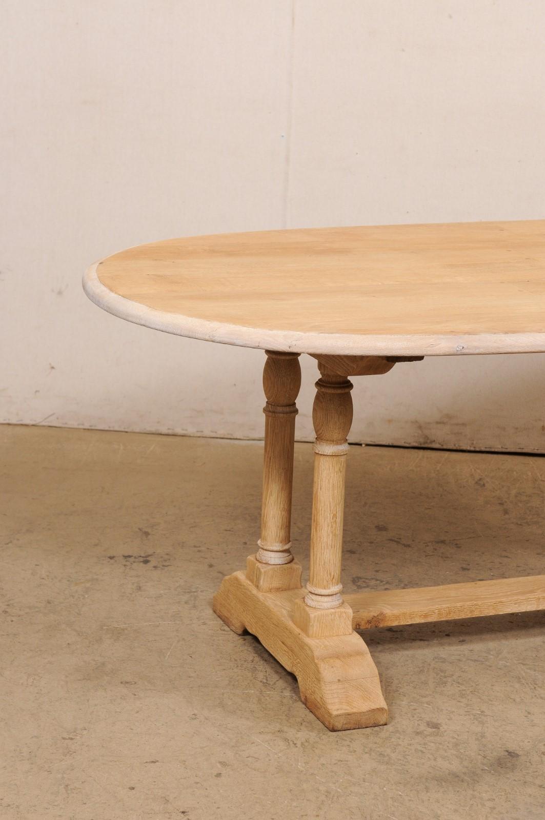 A French Oval-Shaped Bleached Wood Trestle Dining Table, Mid 20th Century In Good Condition For Sale In Atlanta, GA
