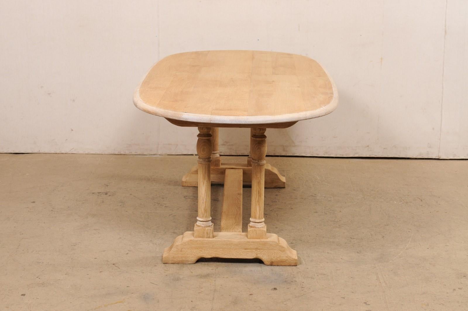 A French Oval-Shaped Bleached Wood Trestle Dining Table, Mid 20th Century In Good Condition For Sale In Atlanta, GA
