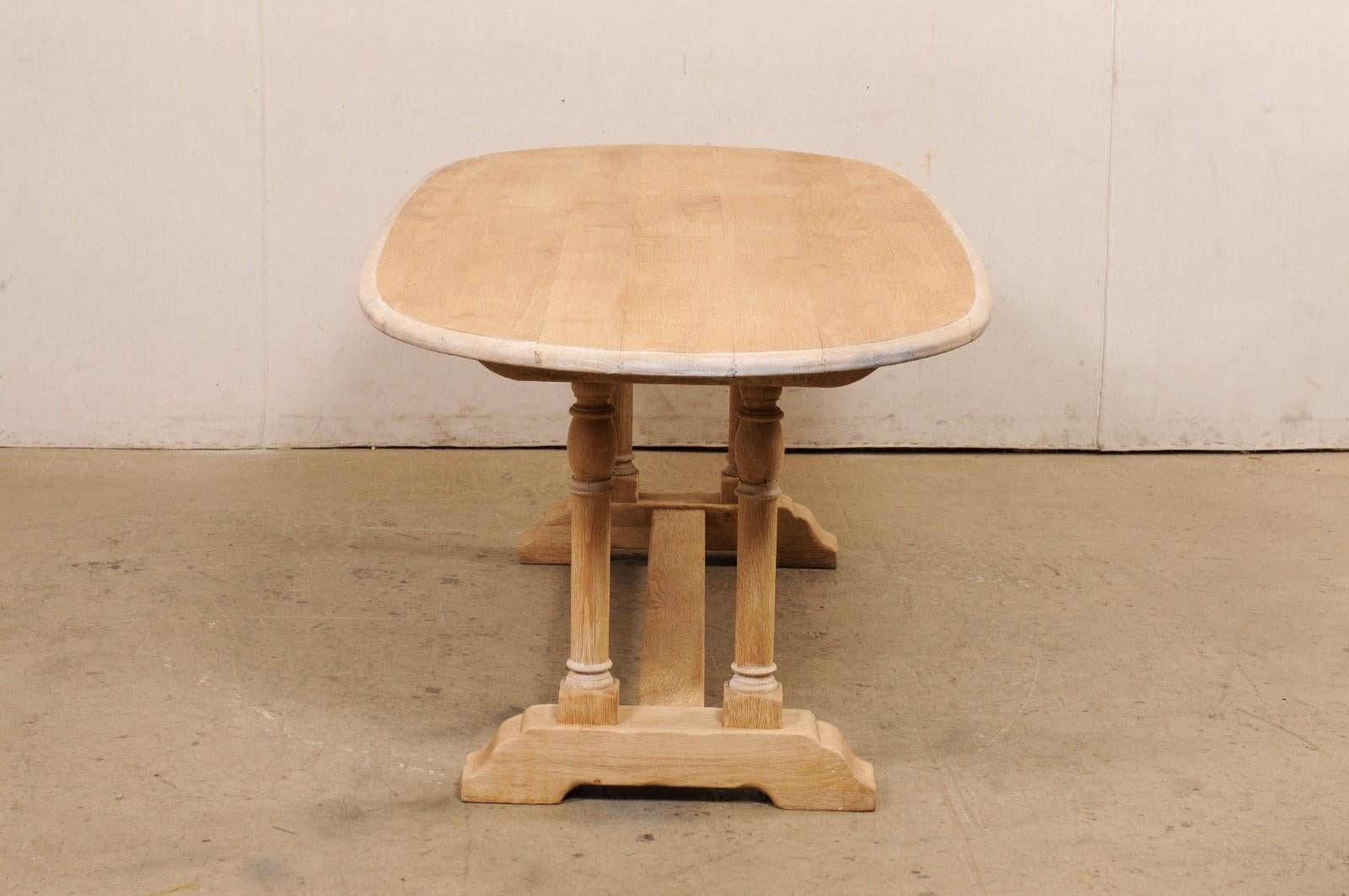 A French Oval-Shaped Bleached Wood Trestle Dining Table, Mid 20th Century For Sale 3