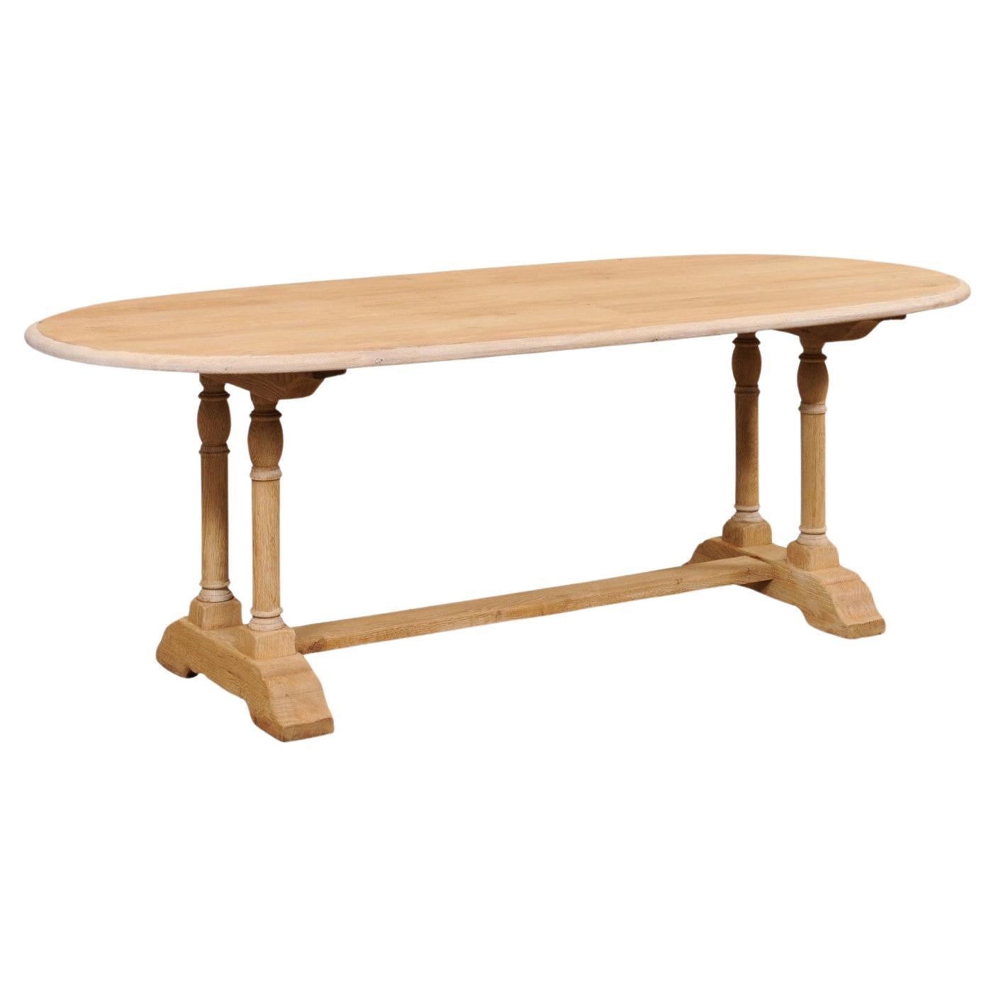 A French Oval-Shaped Bleached Wood Trestle Dining Table, Mid 20th Century For Sale