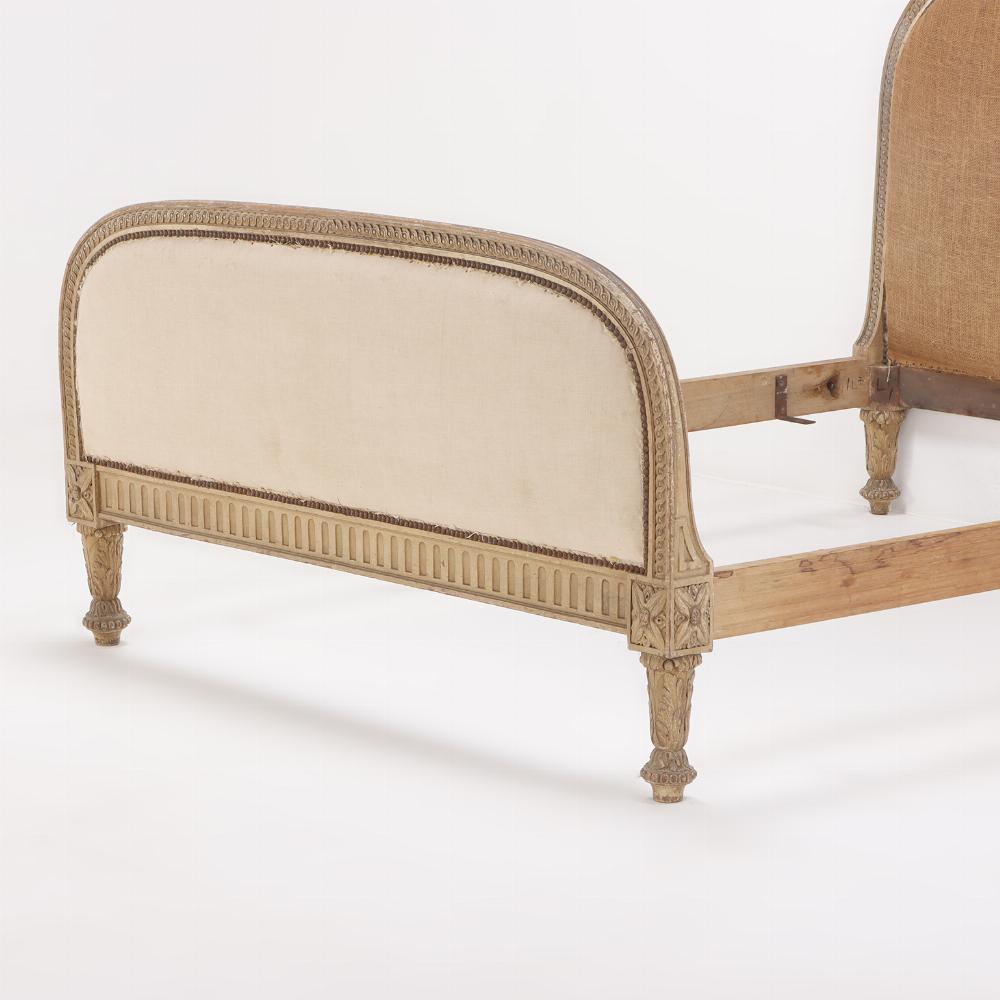 Having an arched headboard and footboard, each with a nice band of carving, the footboard also has nicely curved corners and the whole rests on very elaborate carved feet. This bed is ready to be recovered in a fabric of your choosing and enjoyed in