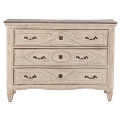 A French painted and carved three drawer commode, 18th century.