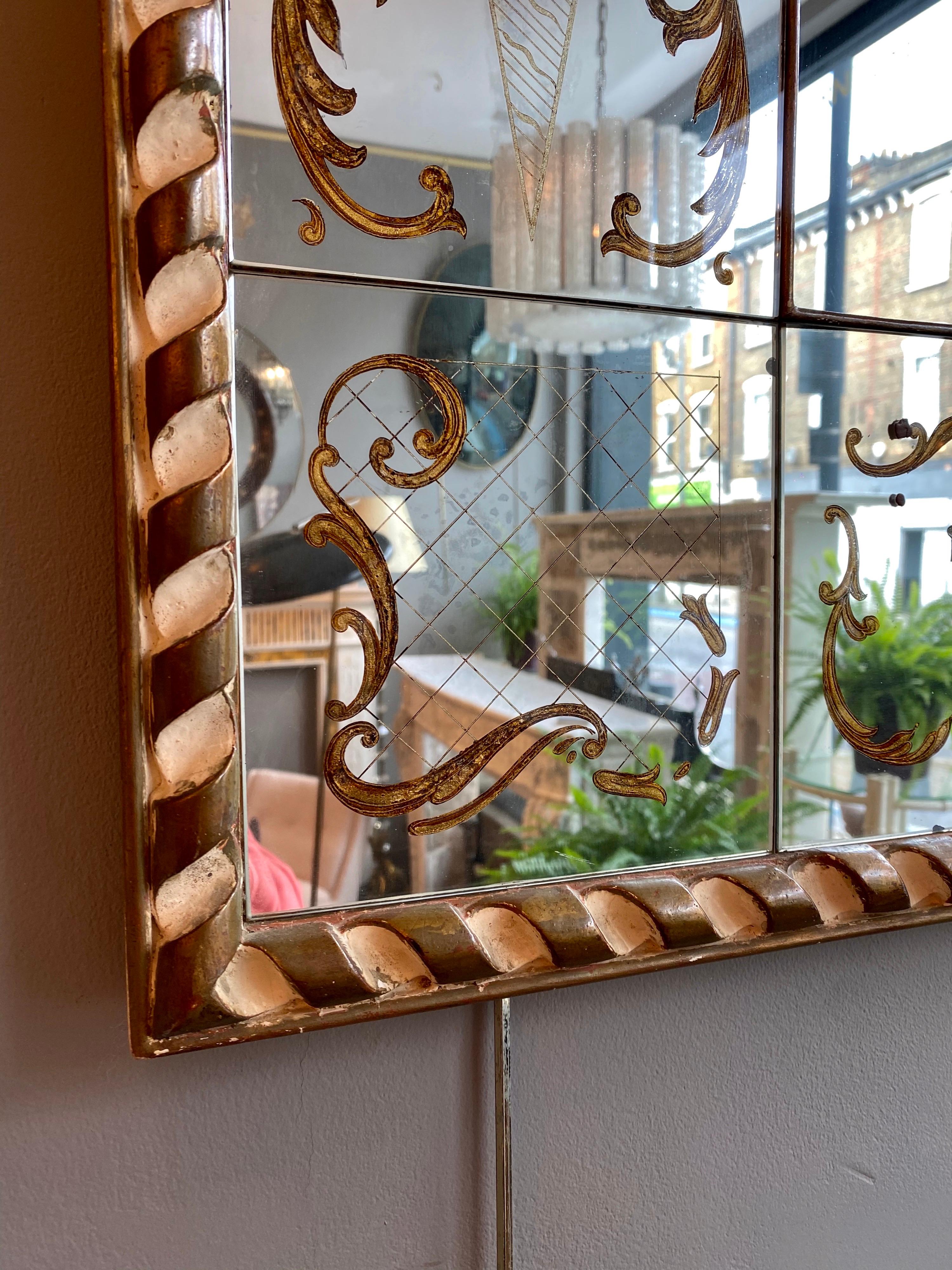 In the style of Robert Pansart and Maison Jansen, this reverse painted panelled églomisé mirror with Venetian themed decoration. Slight damage to bottom panel as shown in image. Gilt rope twist designed frame.