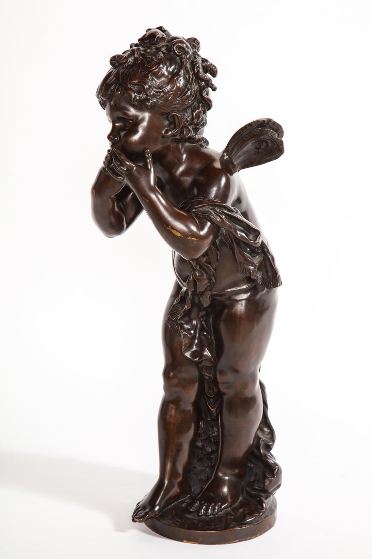A fabulous and large sized Louis XVI style patinated bronze sculpture of a cherub, signed by Auguste Moreau, titled 