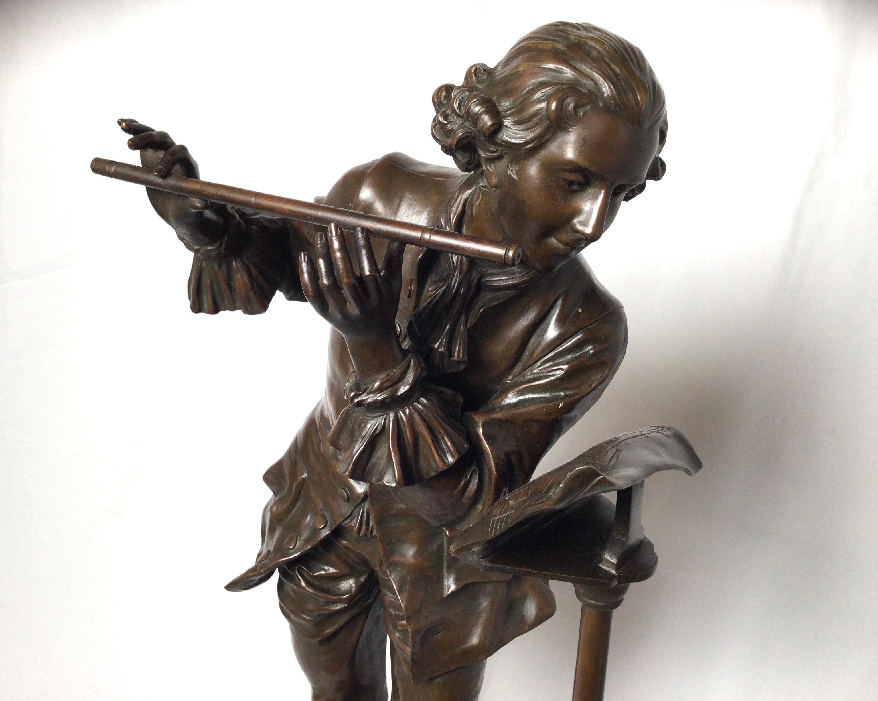A patinated bronze figure of a flute player by Adrinne Gaudes, France, 1880s in a classical 18th century style. The sculpture is signed on the front at the base on a shield label.