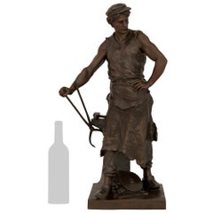 A French patinated Bronze statue of an Ironsmith, signed Emile Louis Picault