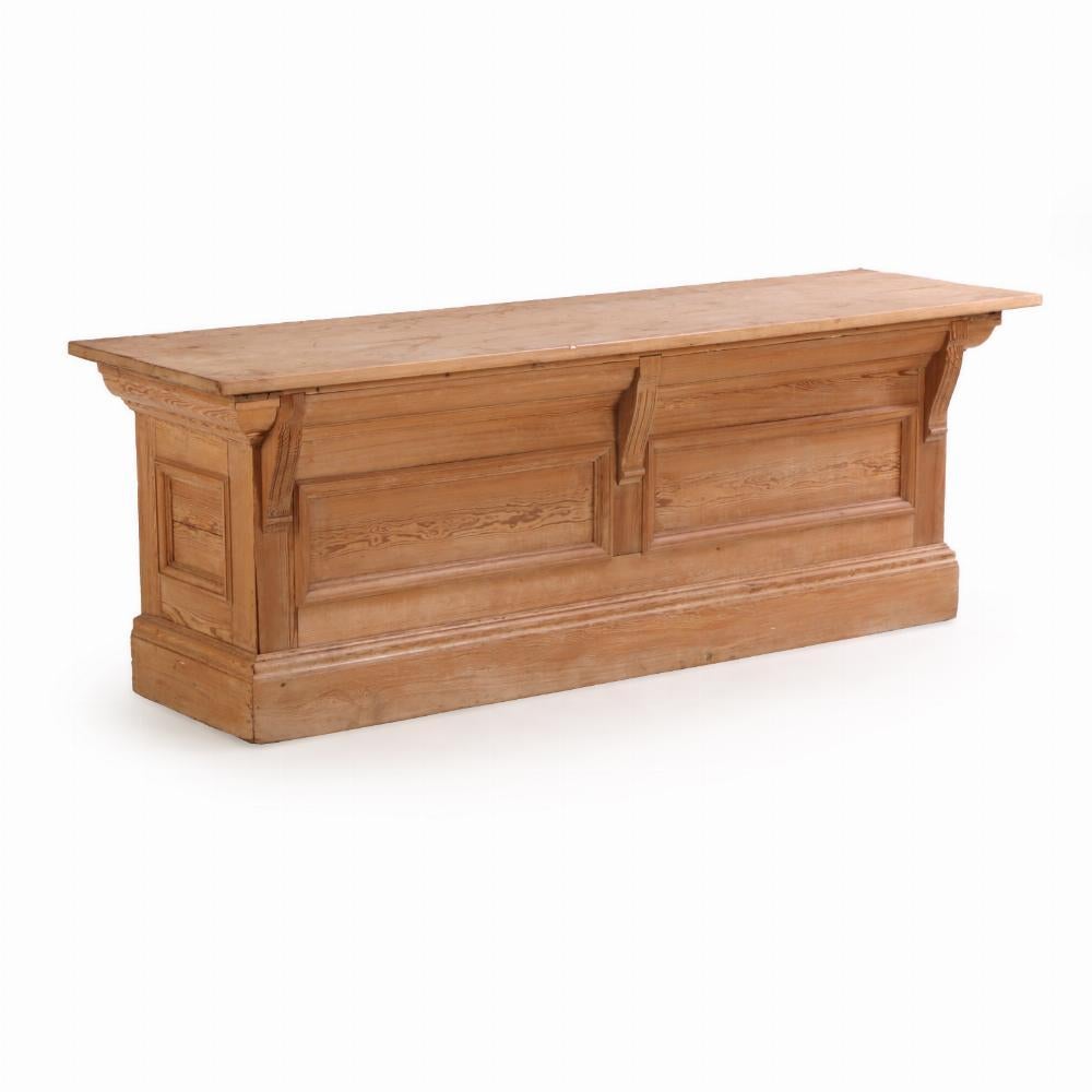 This beautifully preserved French pine store counter offers a clean, timeless look with practical functionality. It is very clean and its generous surface provides ample space for display or work, while two long shelves beneath offer substantial