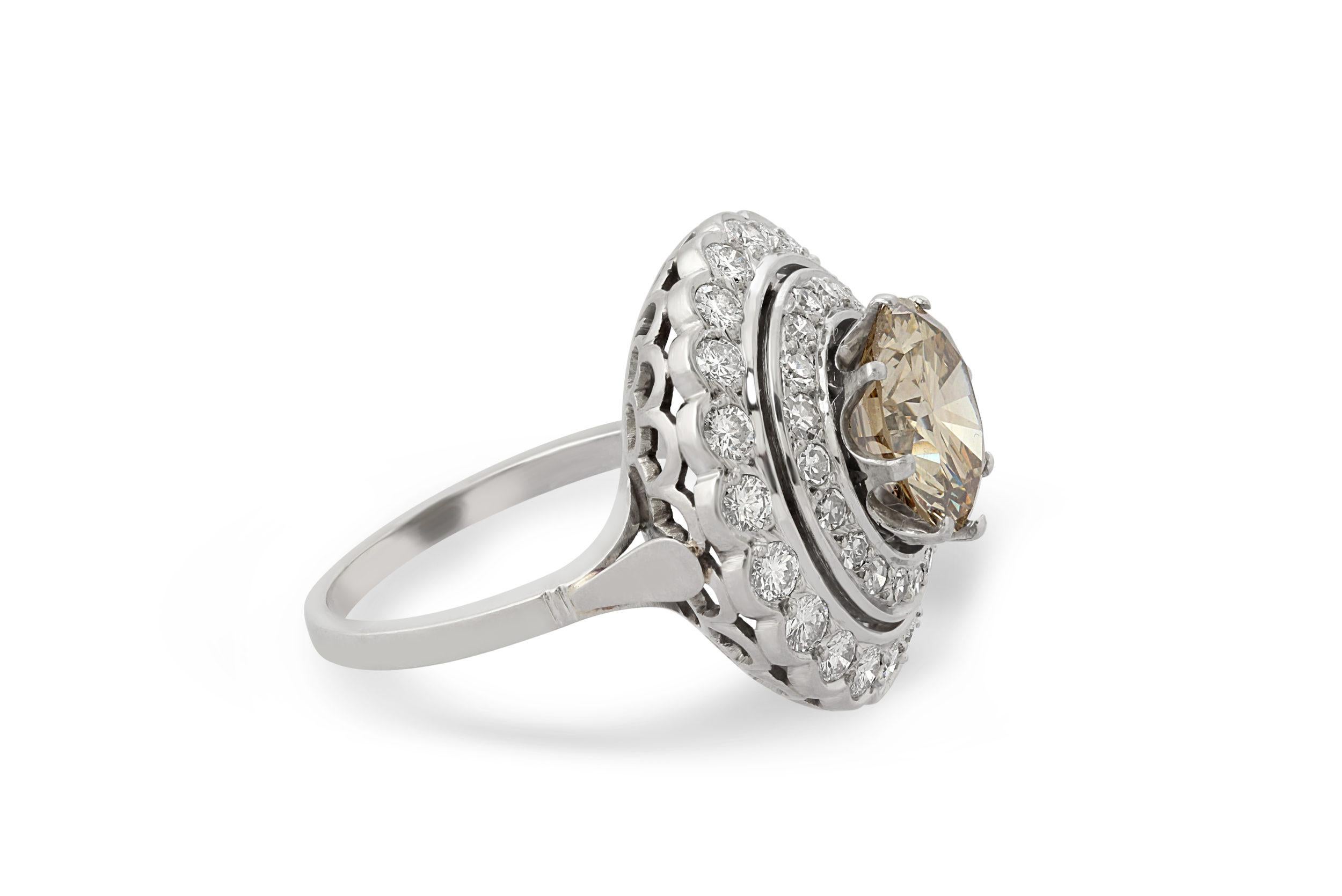 A French platinum and diamond ring, set at the centre with a 3.70 carat fancy brown-yellow diamond.