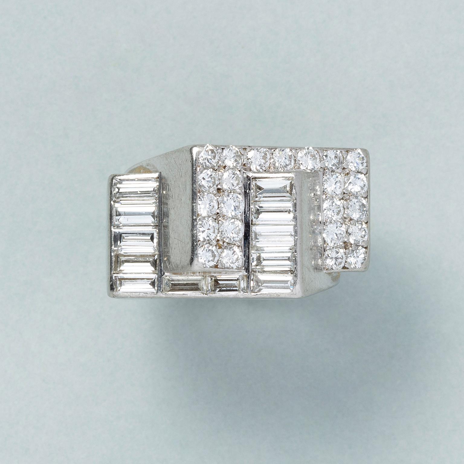 An art deco platinum ring formed from two optically interlaced surfaces, one set with baguette cut diamonds (app. 1.4 ct, G-H, Vs-Si) and the other surface is set with brilliant cut diamonds (app. 0.5 crt, G-H, Si), with French marks and French