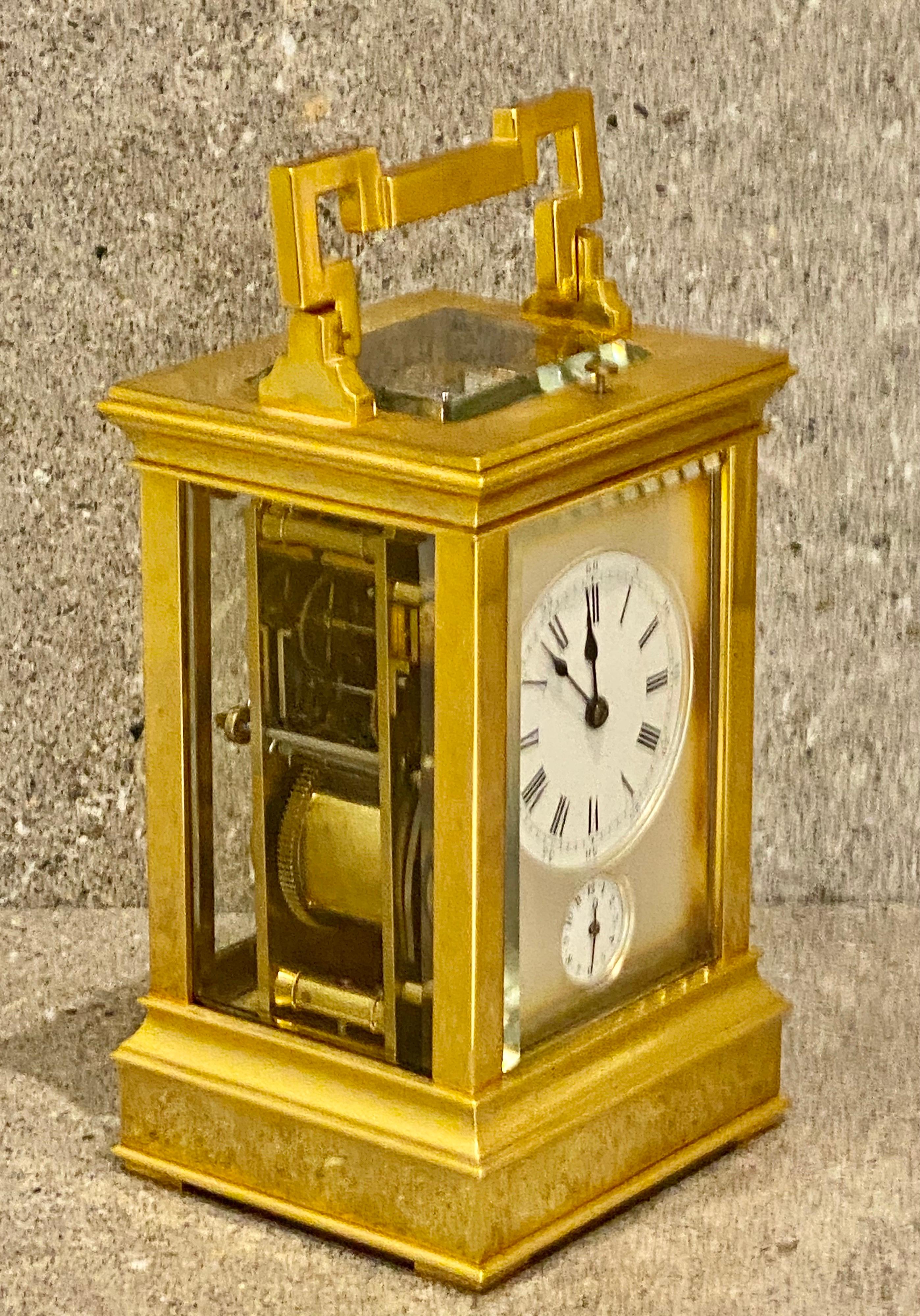 This is a very attractive quarter striking carriage clock. The case retains its original gilding.
The substantially made and fully glazed case with attractive ripple mouldings, A repeat button to the top. With a beautiful frost gilt mask to the