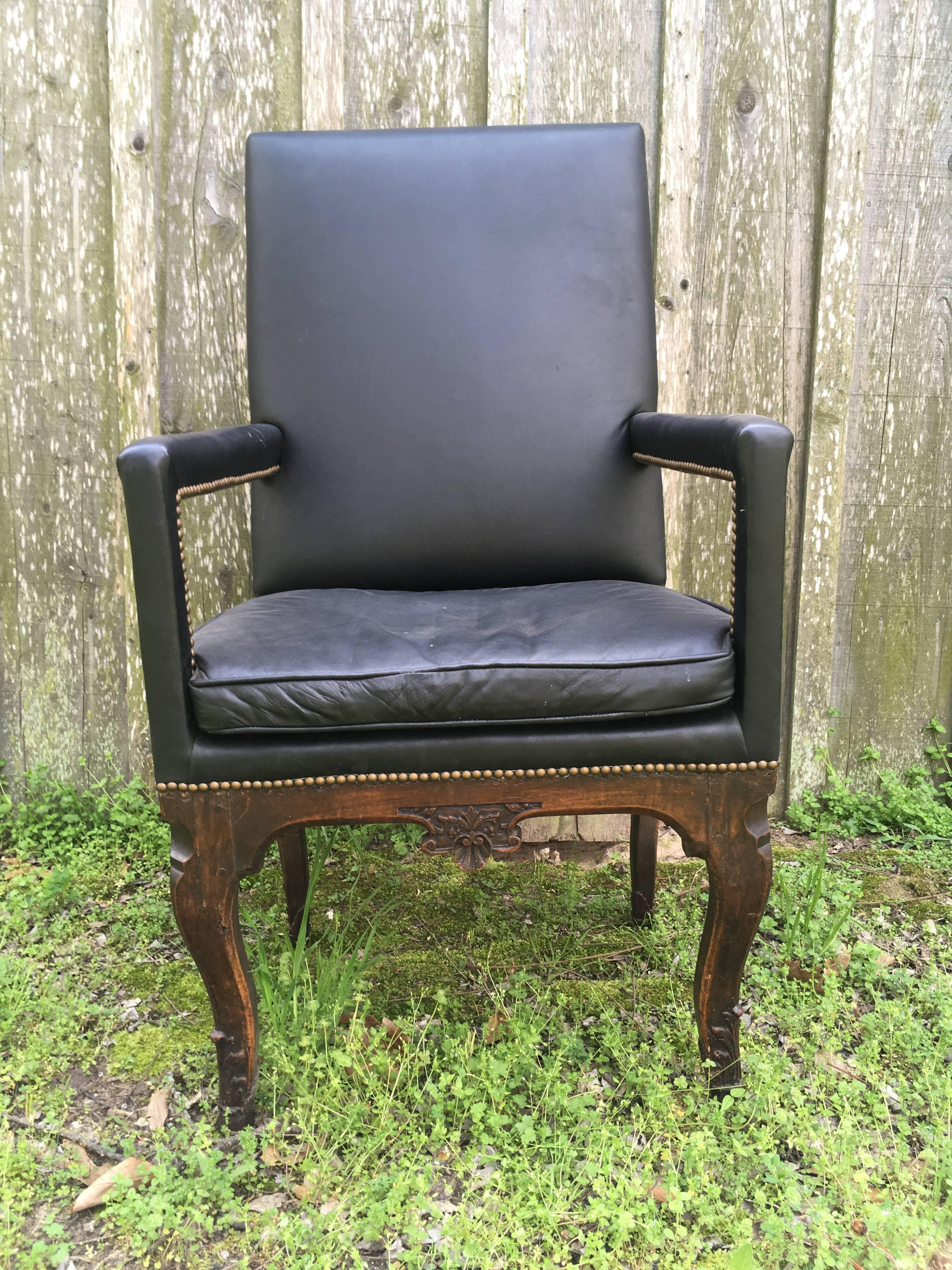 A French Regence period armchair in carved walnut with a very tall back and seat. 
This chair is ideal for a tall person.