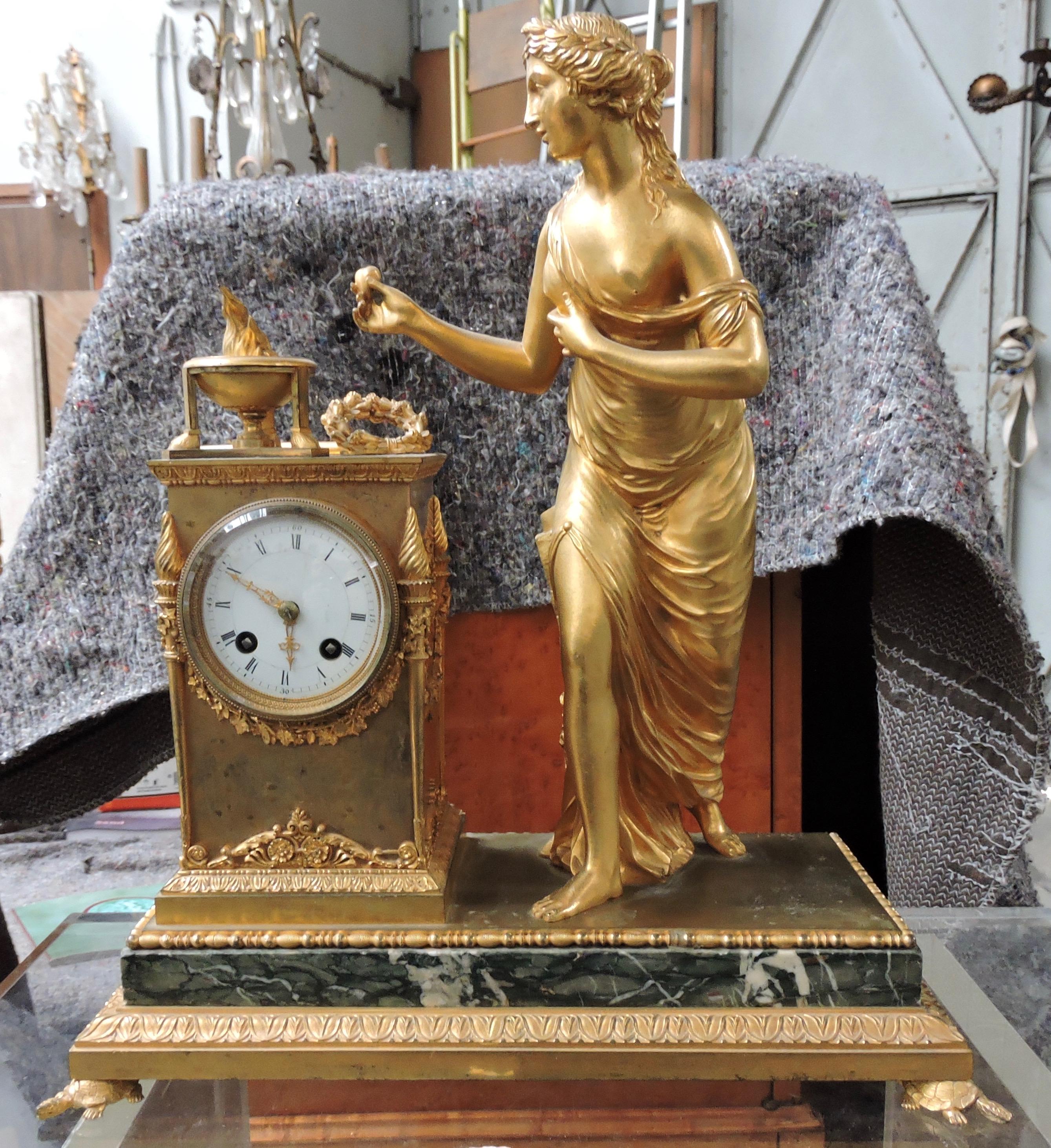 A French 19th century Restauration marble and ormolu mantel (fireplace) Clock, 
Designed with a Vestale Woman watching the Vesta Temple Fire
On a green 