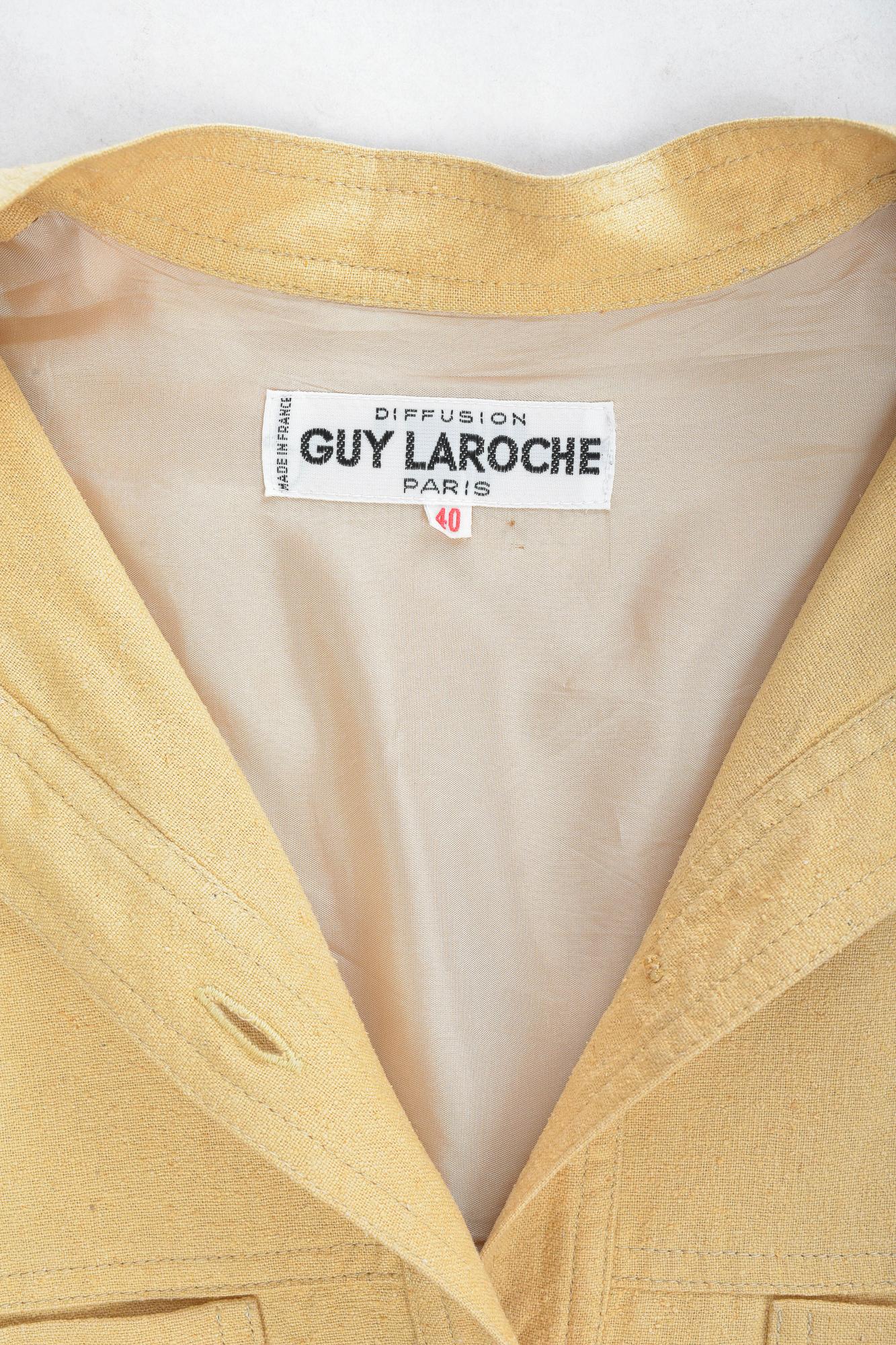 Circa 1975 - 1980

France

Rare Saharienne shirt blouse from Guy Laroche Boutique dating from the early days of the famous Parisian fashion house. Blouse with long sleeves and Mao collar, four stitched pockets and matching plastic
