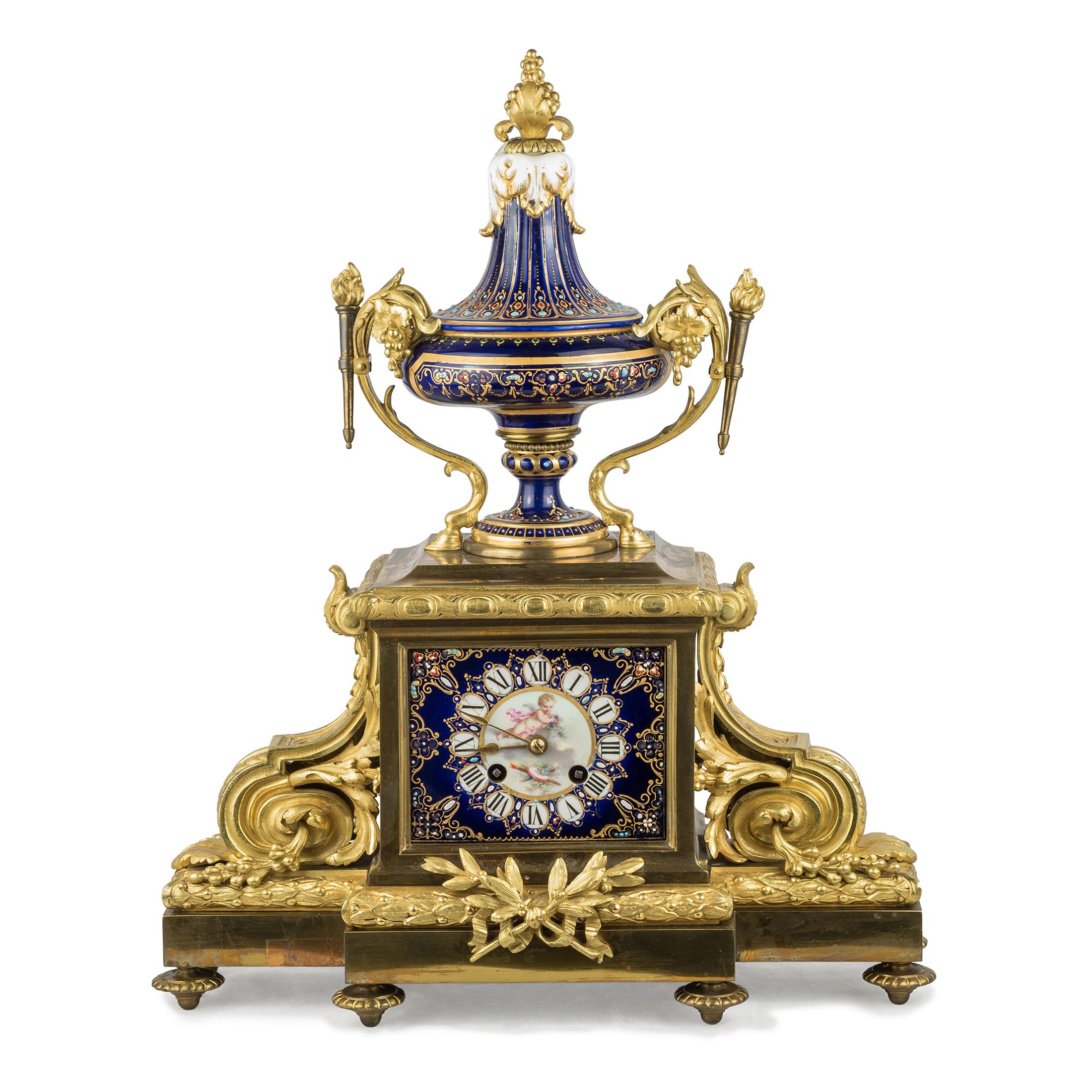 A magnificent Sèvres-style gilt bronze and jeweled porcelain clock set.
The fine pair of Sèvres-style ormolu mounted covered cobalt blue ground porcelain vases with hunting scene.
Origin: French
Date: 19th century
Dimension: Clock 17 1/2 x 14