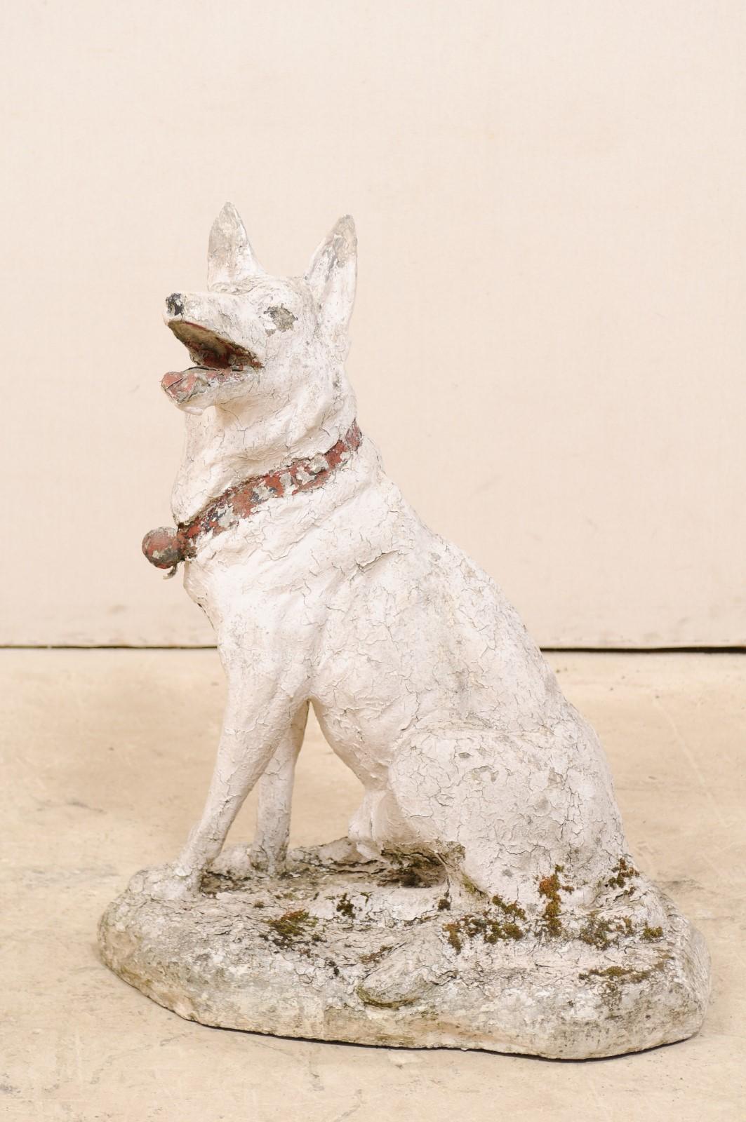 A French large-sized shepherd dog of cast stone statue from the early 20th century. This antique statue from France, created in cast-stone, in the image of a handsome adult Shepherd dog, in seated position with alert ears, open mouth and collared