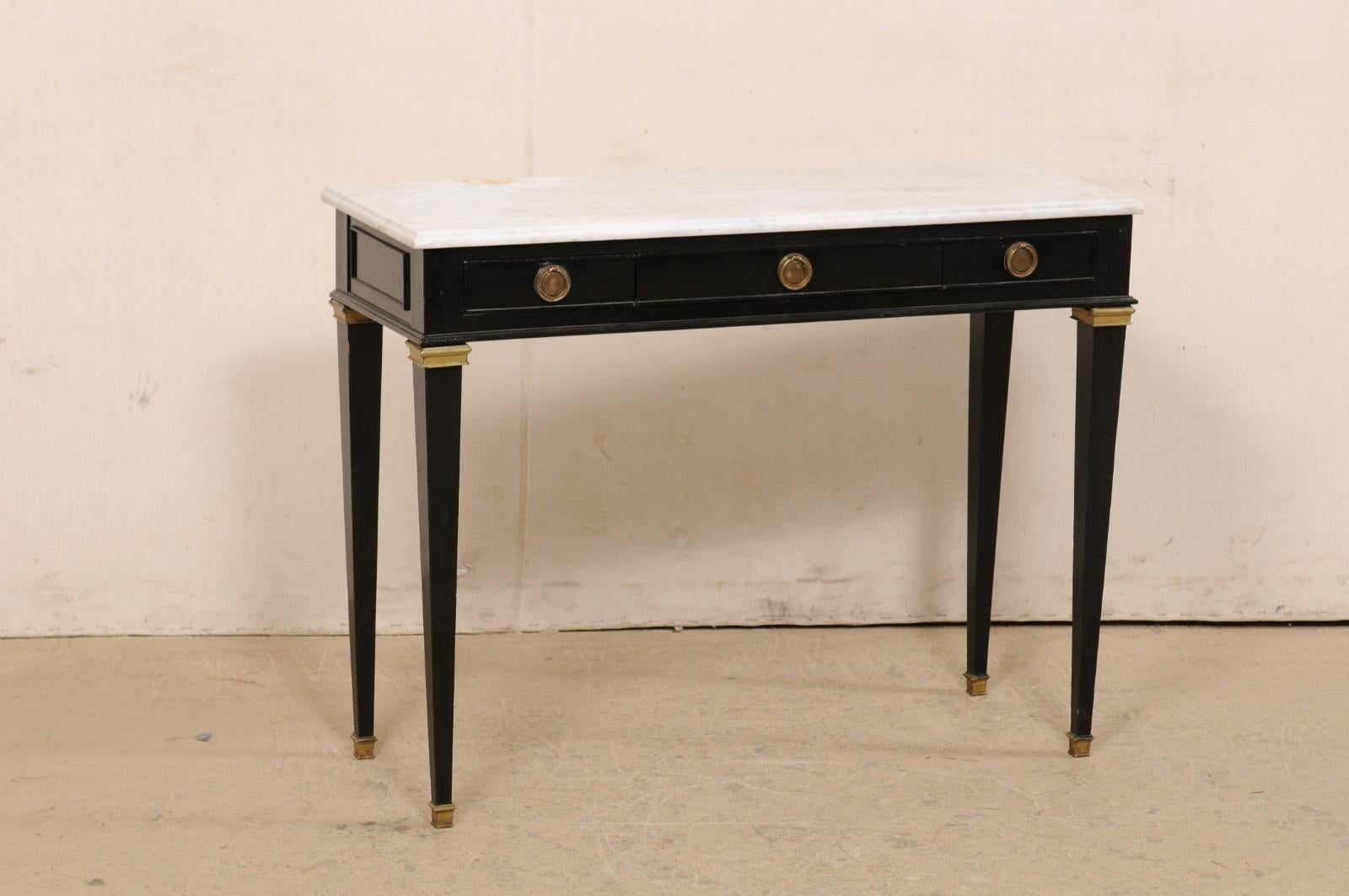 A French painted console table with drawers and its original marble top. This vintage table from France features a 39