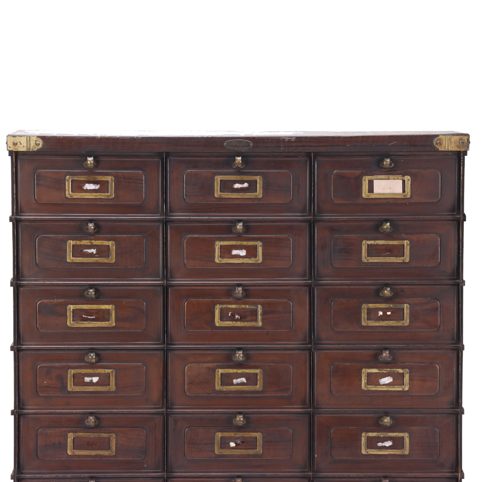 Brown steel apothecary-style cabinet with 30 individual drawers, made in France by Strafor, Forge de Strasbourg. The substantial, circa 1920 cabinet is beautifully forged with intriguing details, including brass accents on the drawer fronts as well