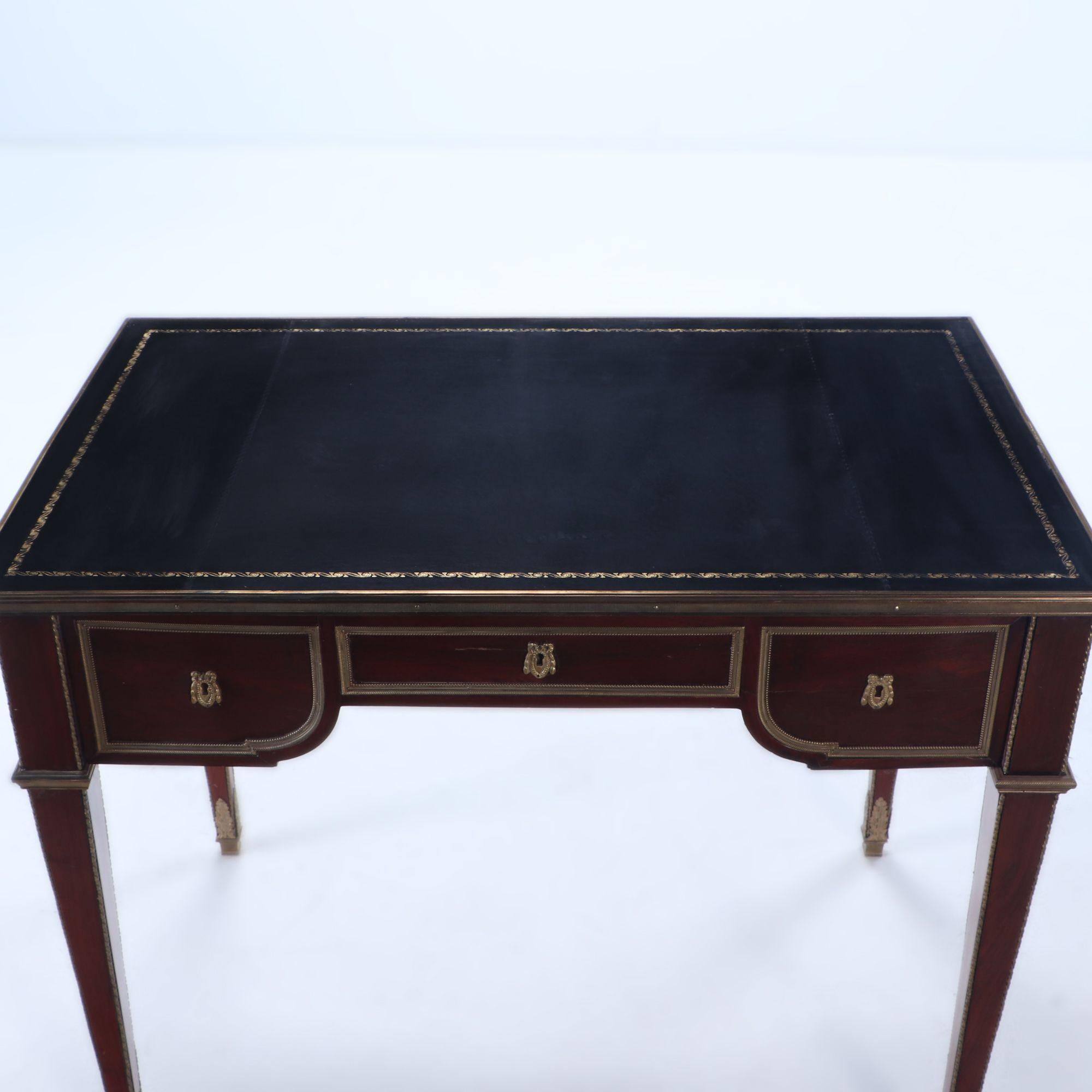 Louis XIV A French Louis XVI style three drawer mahogany bureau plat desk C 1930 For Sale