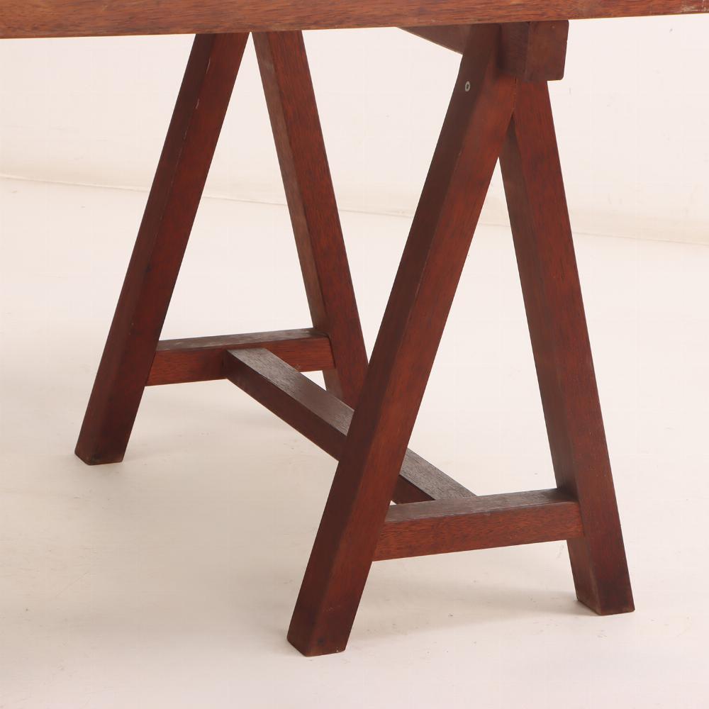 The design reflects functional modernism, with clean lines and practical proportions, while the durable laminate top offers a smooth, low-maintenance work surface. The warm tone of the mahogany edge and 
