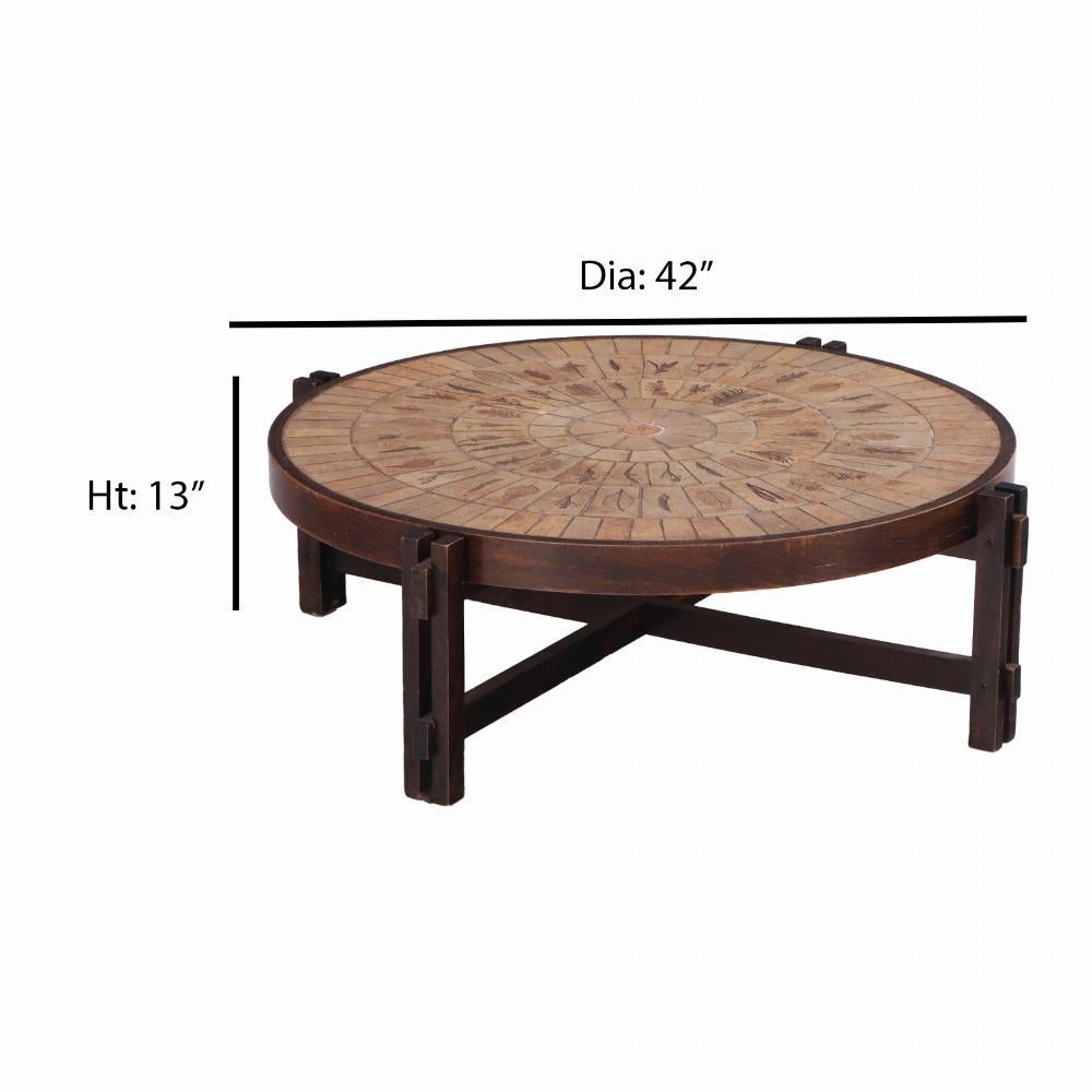 A highly desirable form by this designer, the round wooden base supports ceramic tiles with leaf patterns, signed signed R Capron. Each tile has the impression of a plant native to France surrounding Vallauris where Capron founded Atelier