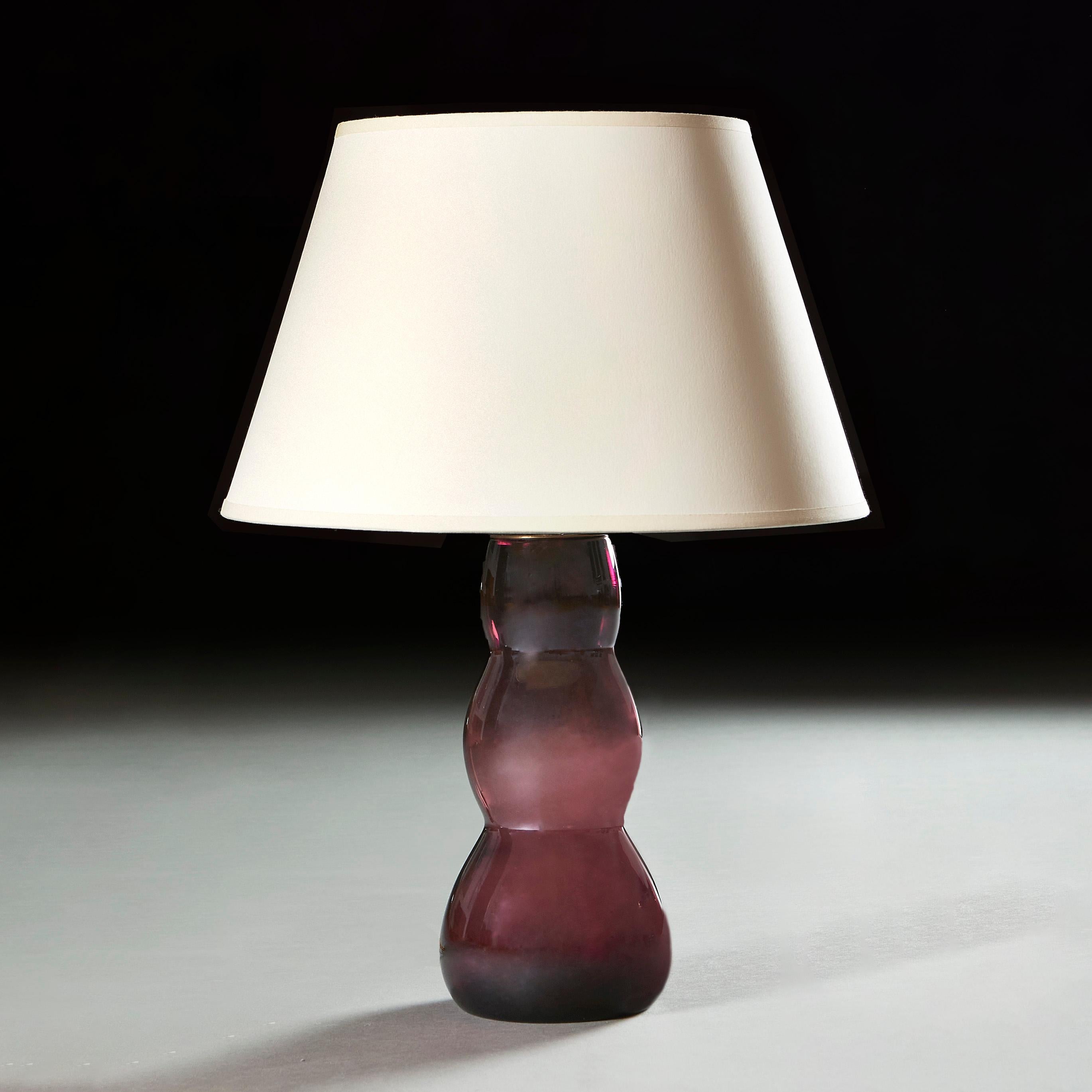 France, circa 1950.

A midcentury French art glass vase of aubergine colour and triple gourd form, now wired as a lamp.

Measures : Height of vase cm 30.50cm
Height with shade cm 55.50cm
Diameter of base cm 14.00cm.

Please note: This is