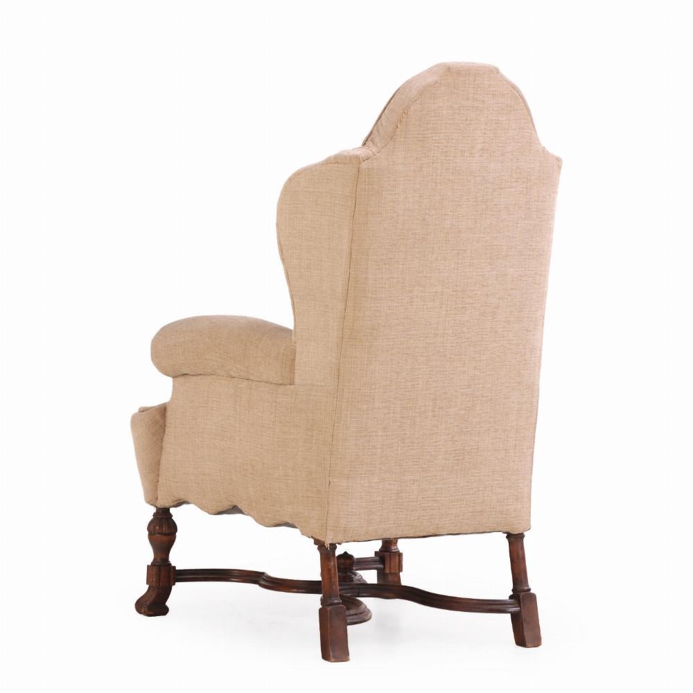 With a high arched back and out-curved arms on turned and reeded legs, joined by scrolled stretchers and terminating with scrolled feet, this stately chair is fit for your living room, study or quiet reading spot in your bedroom.