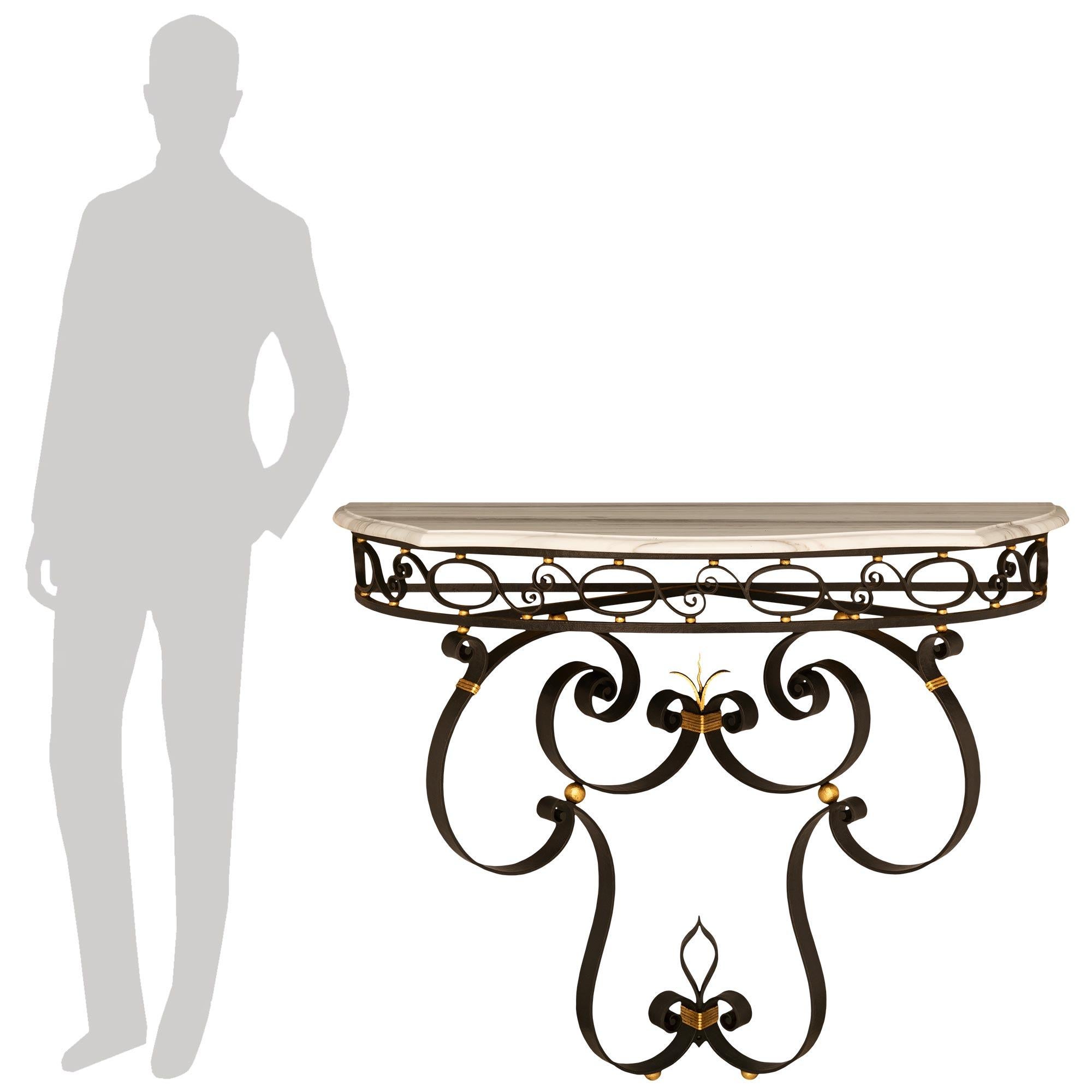 An elegant French turn of the century Wrought Iron, Gilt Metal and marble console.
