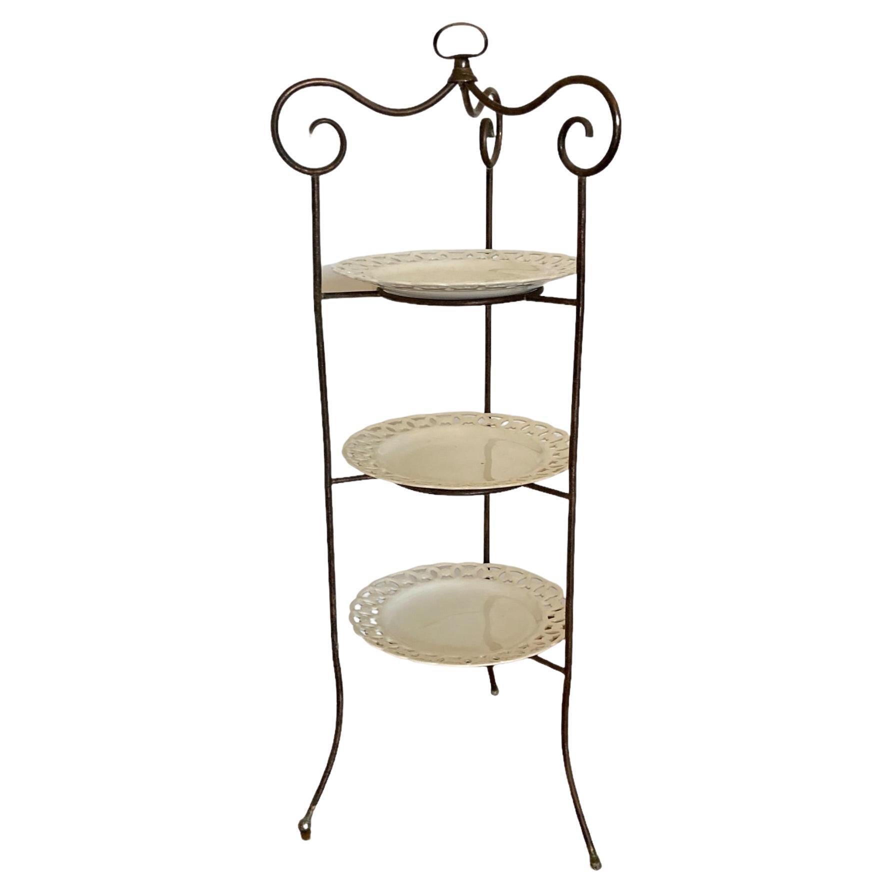 A French Wrought Iron three tier cake stand with ornate porcelain plates For Sale