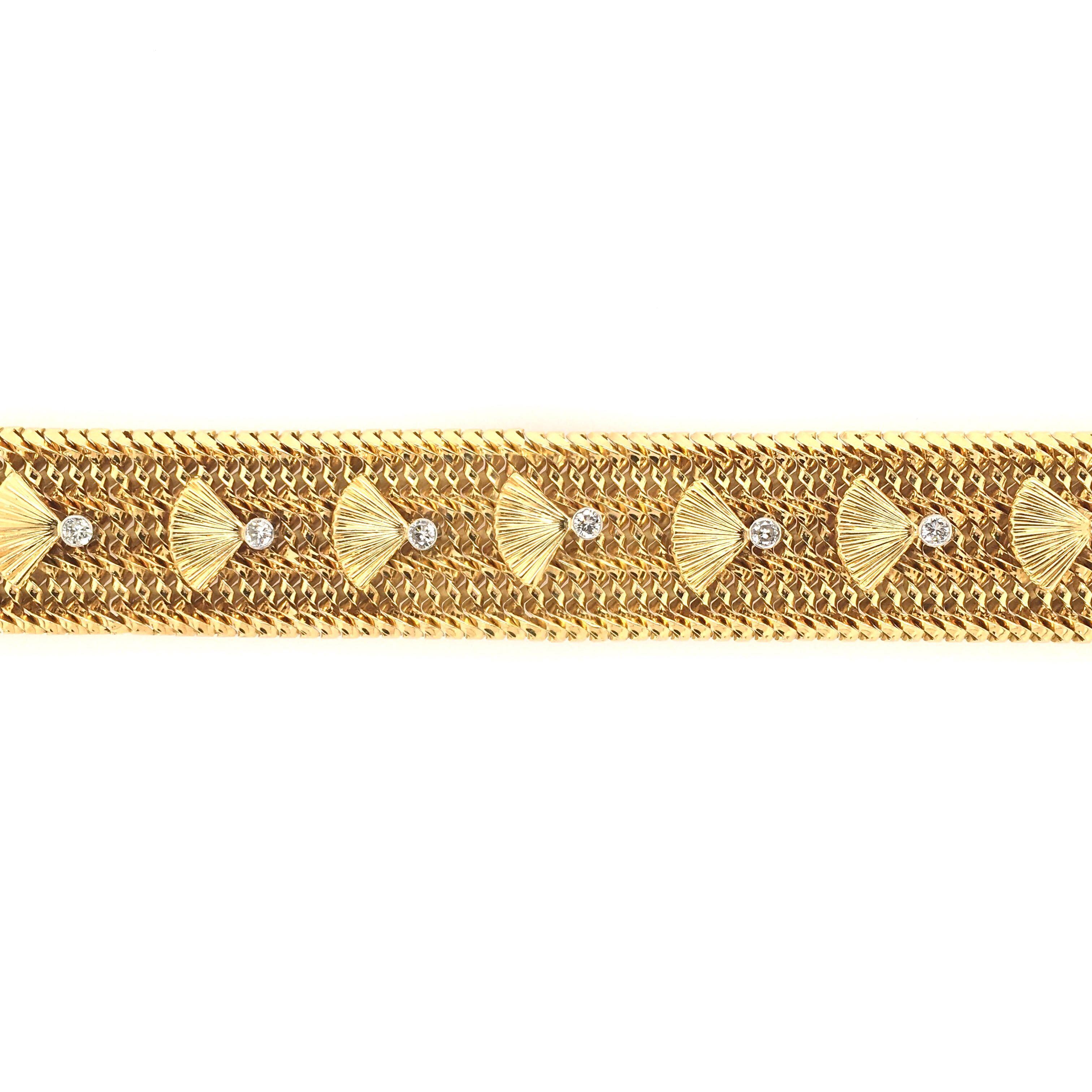 An 18 karat yellow gold and diamond bracelet. French. Circa 1940. Designed as a mesh band, set with polished and fluted gold fan motifs and circular cut diamonds. Length is approximately 7 inches, gross weight is approximately 77.7 grams. With