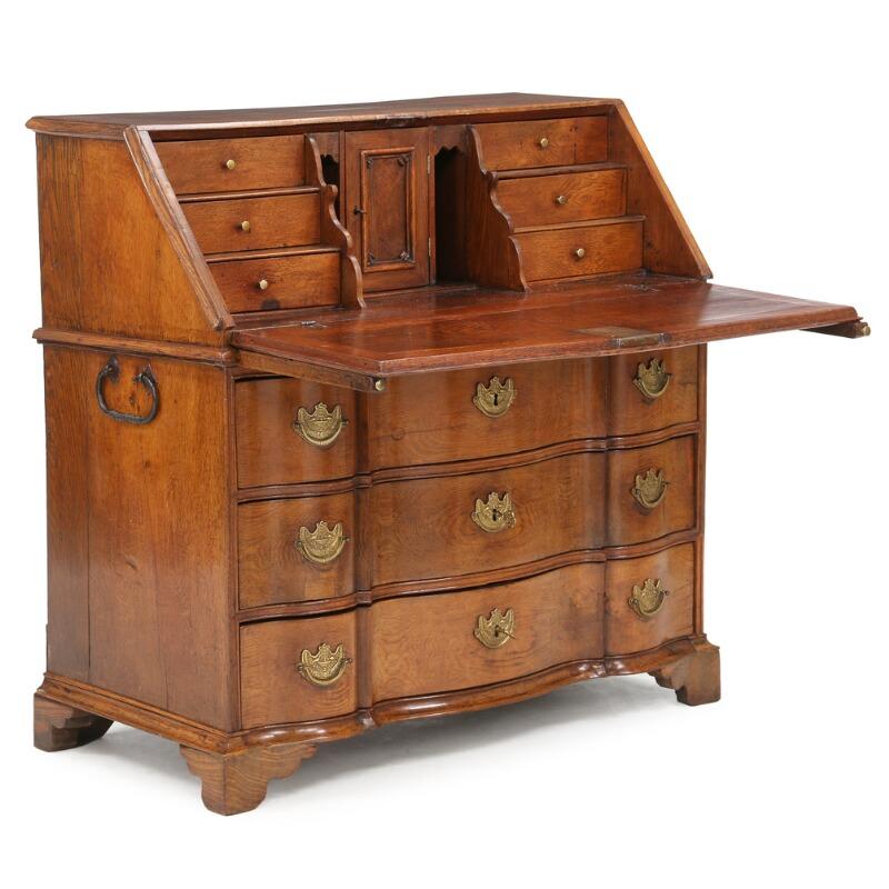 The Frisian bureau is in excellent condition with bracket feet and curved front on either side. It still retains the original brass hardware drawer pulls. The inlaid Frisian stars are beautifully executed on the front of the bureau and the