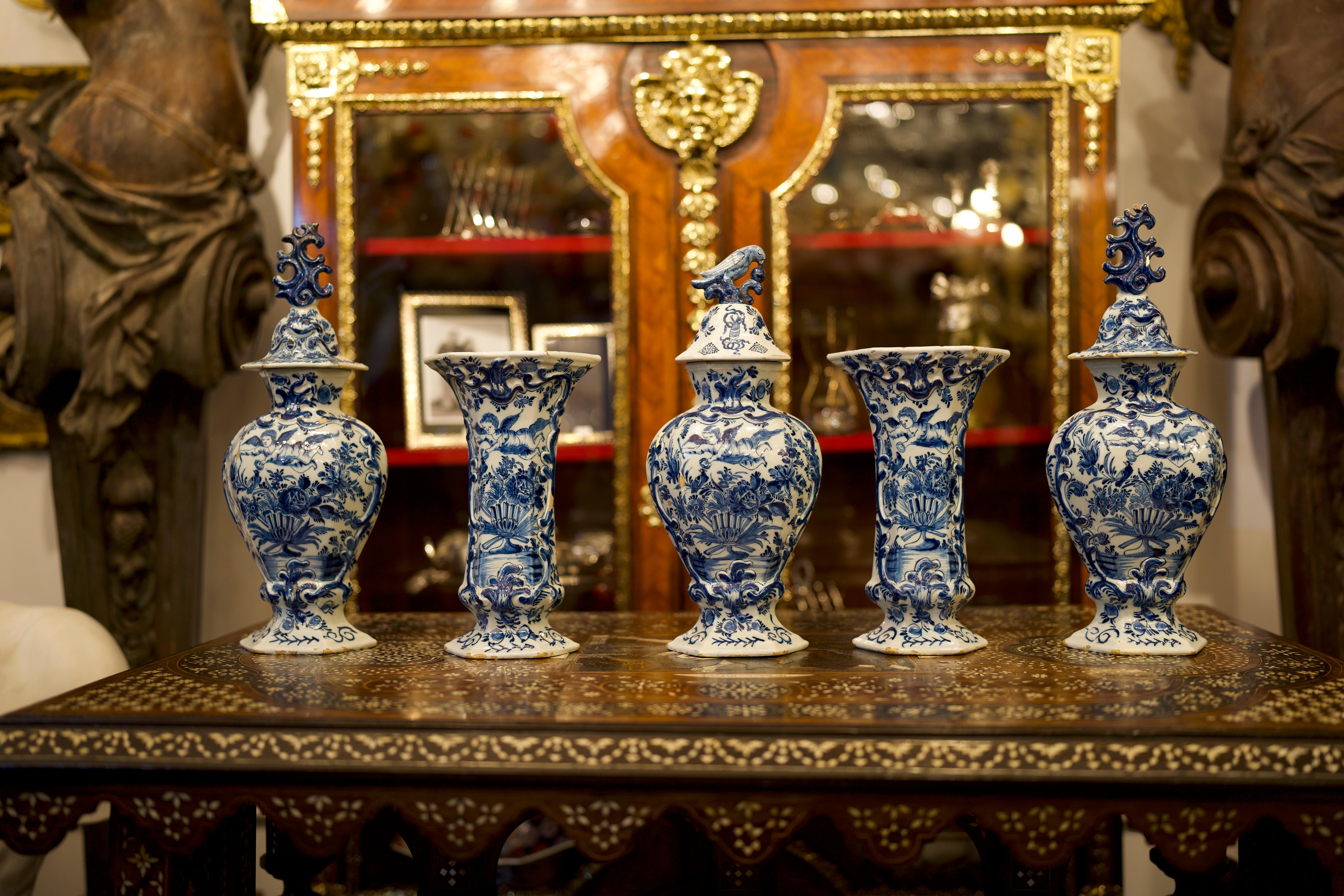 A stunning Garniture Of Mid 18th Century Dutch Delft Blue And White Vases.
The set molded with petal-form segments throughout and each raised on a foot with convex profile above a set-in foot ring encircling the recessed base centered with lingzhi