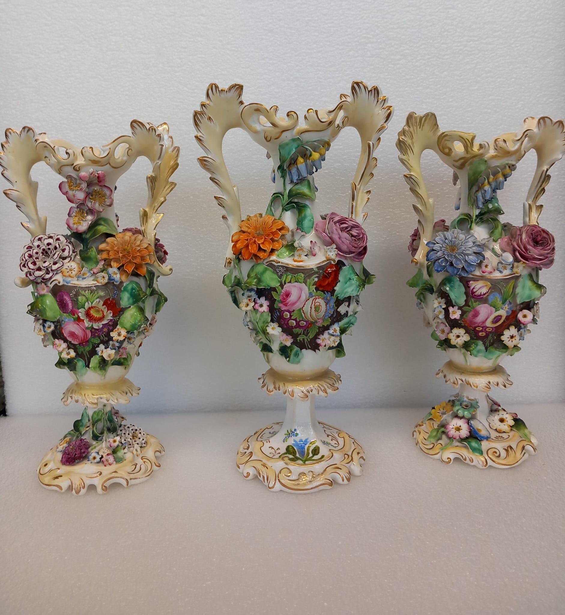 Victorian A garniture of three antique English porcelain vases, heavily decorated  For Sale