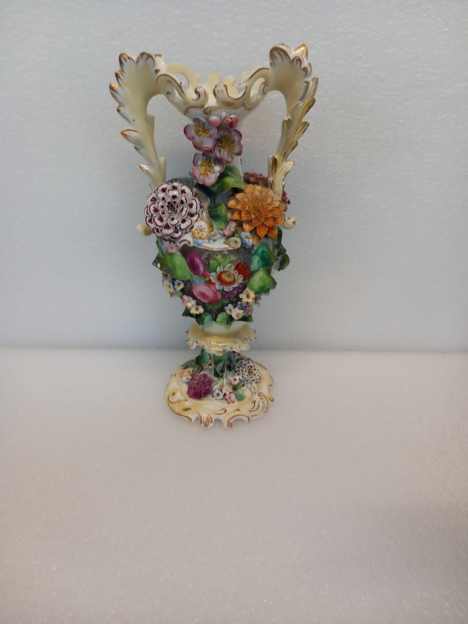 Ceramic A garniture of three antique English porcelain vases, heavily decorated  For Sale