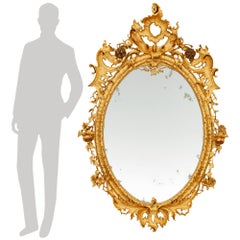 A Genovese early 19th century patinated Wood and Giltwood mirror