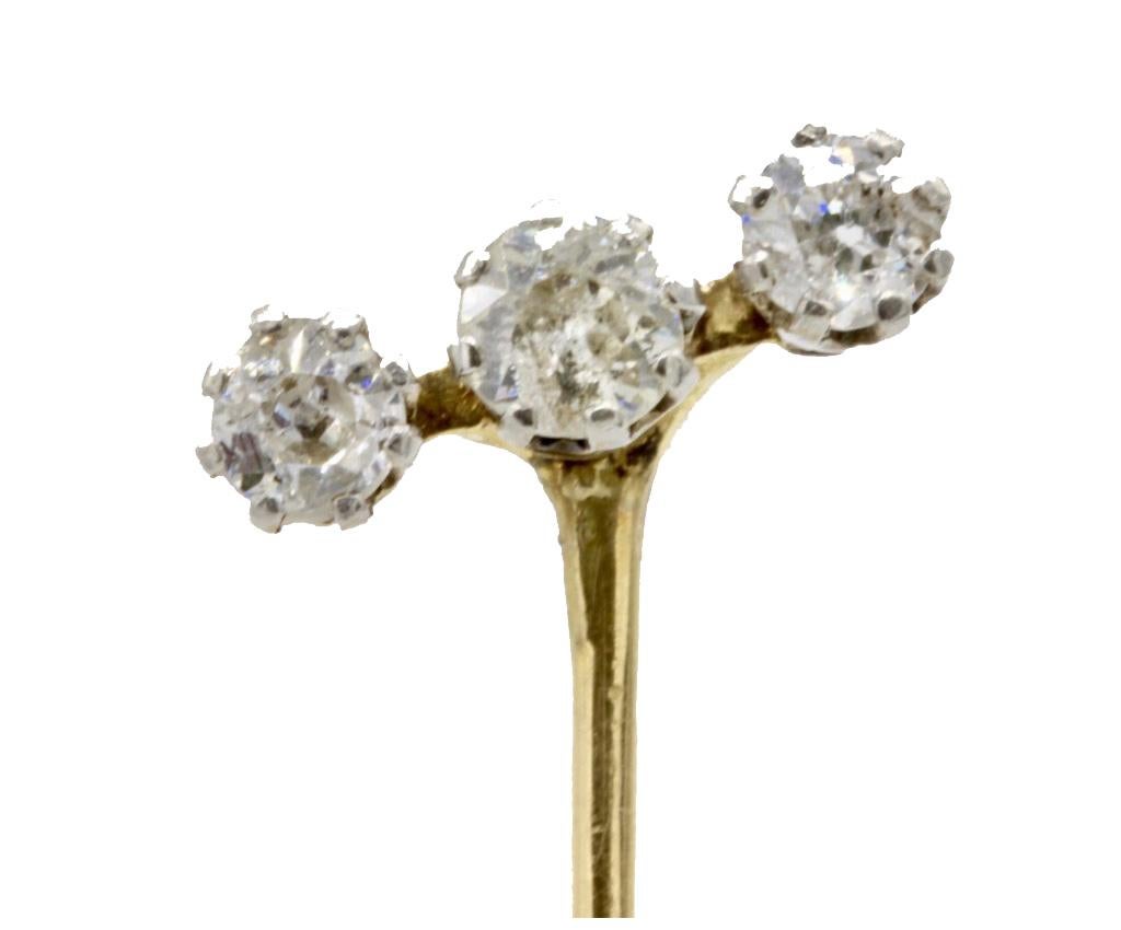 A Gentleman's 14 Kt yellow gold and three diamond stick pin. The three diamonds with eight claw settings in a tilting row.
Total weight of diamonds approximately 0.6 Ct.
Unmarked but tests for 14 Kt gold.
All stick pins are sold with a modern 9 kt
