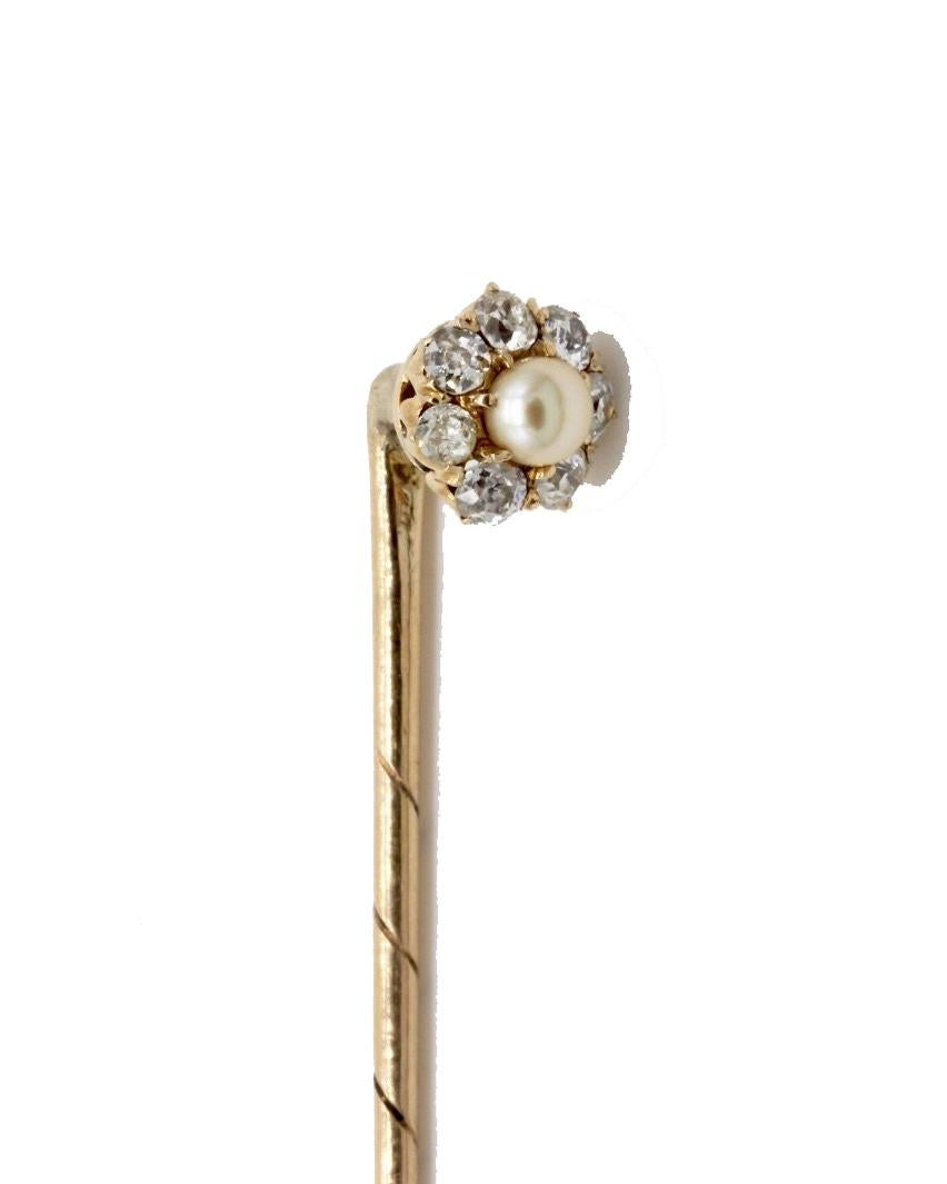 A Gentleman's 14 Kt Yellow Gold Diamond And Pearl Flower Head Stick Pin. 
The central pearl surrounded by seven old cut diamonds, the head detachable with a screw fitting to allow it to be worn as a collar stud.
Total weight of diamonds
