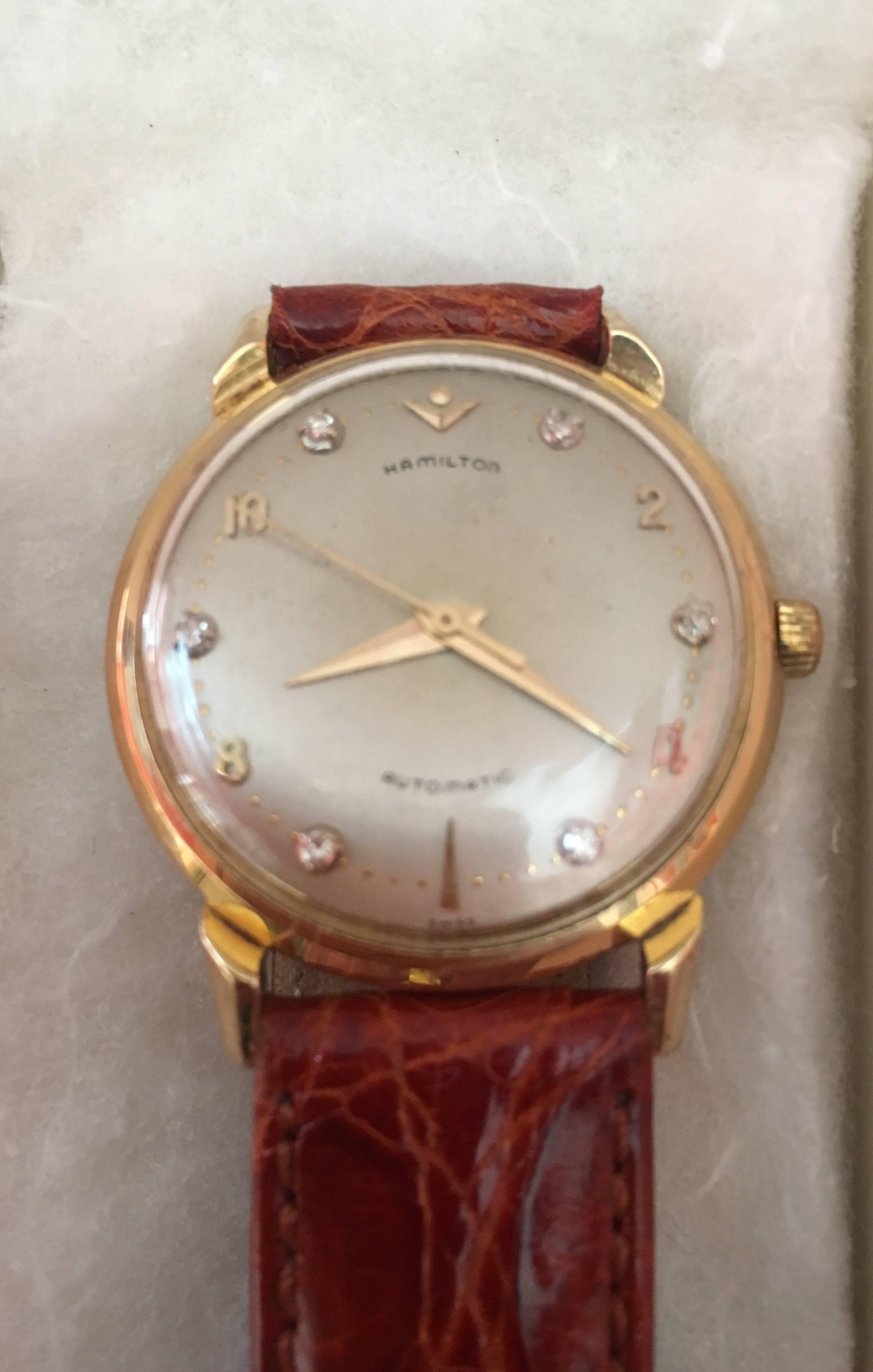 A gentleman's circa 1950's Hamilton in solid 14 karat yellow Gold and 6 Diamonds automatic wristwatch, fully  serviced and in working condition.
Round case, white dial with set diamond numerals.
The Bracelet is a new brown Alligator.
Provenance