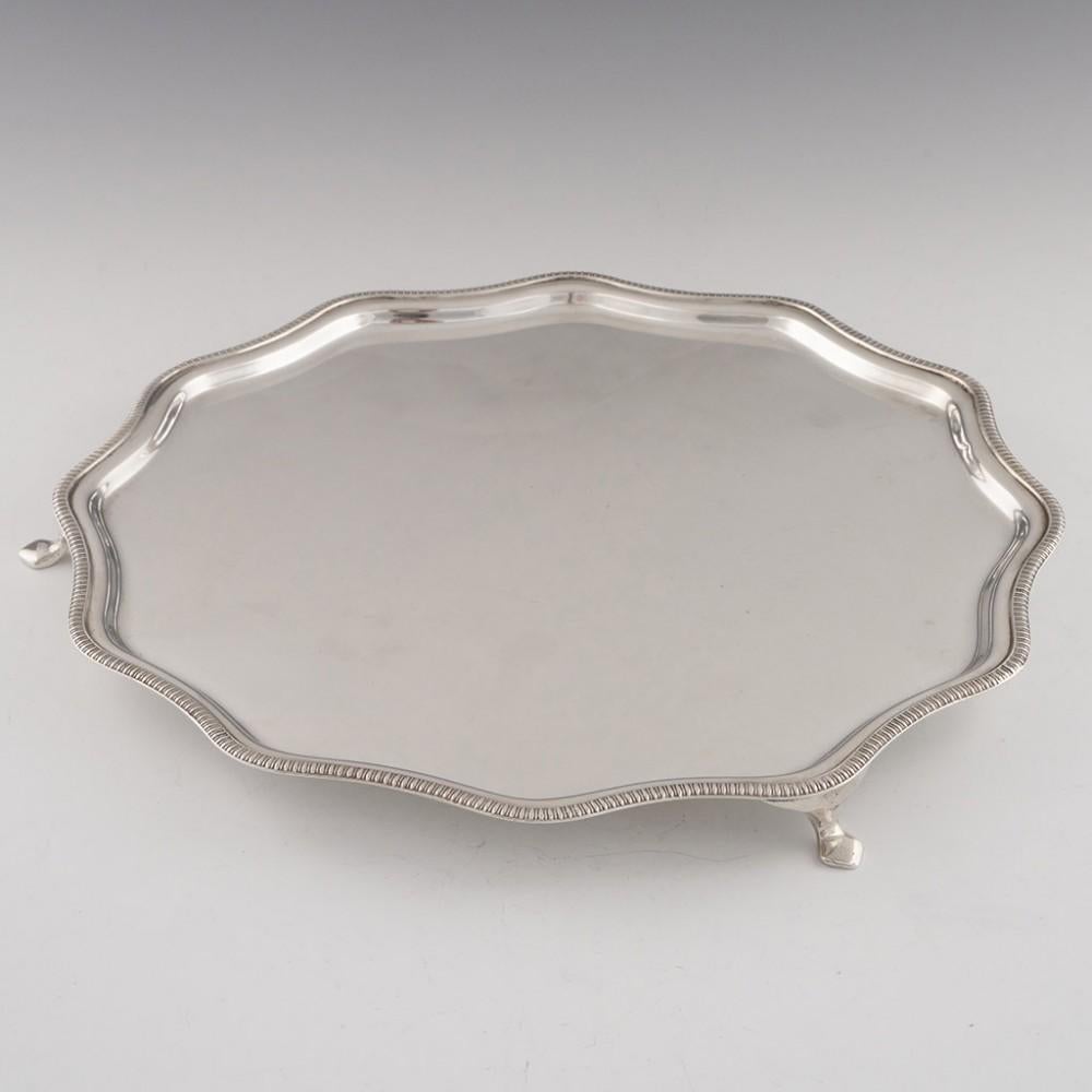 A George VI sterling silver salver. With a contoured gadrooned edge, raised on three simple hoof feet. Hallmarked in 1936 for Frank Cobb & Co.Ltd.