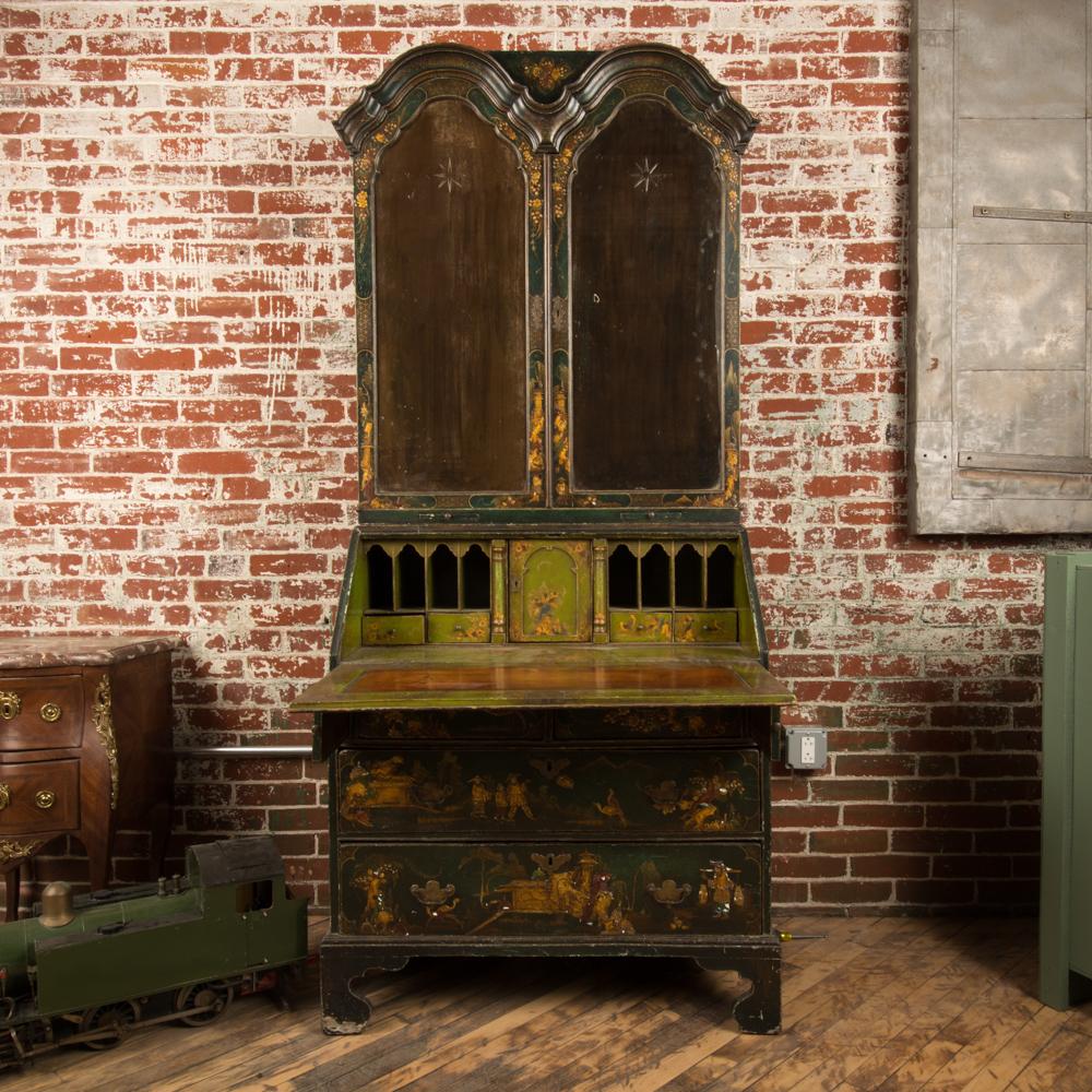 A George I green Japaned and parcel gilt lacquer bureau cabinet with chinoiseries decoration, eighteenth century. Interior fitted with shelves, and drawers.