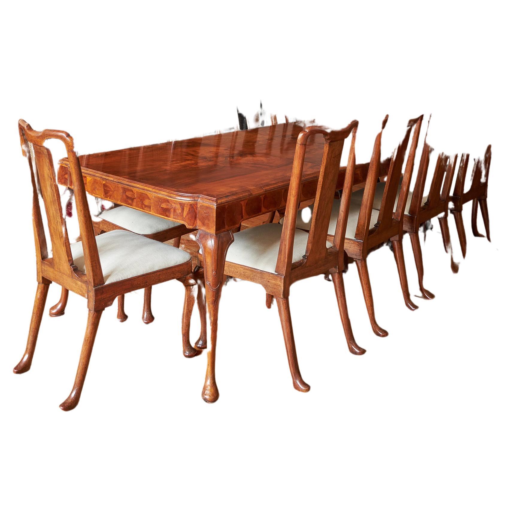 British A George I style walnut veneer extending dining table and twelve dining chairs For Sale