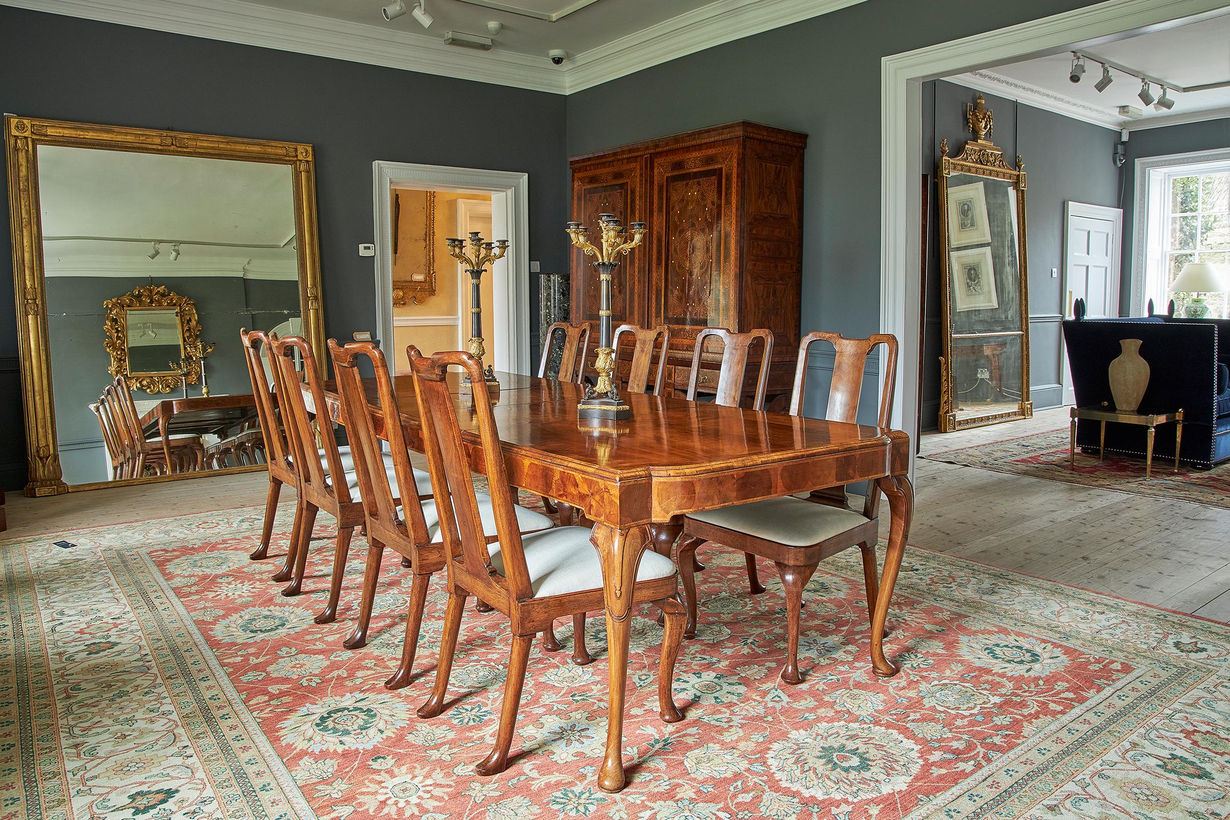 Veneer A George I style walnut veneer extending dining table and twelve dining chairs For Sale