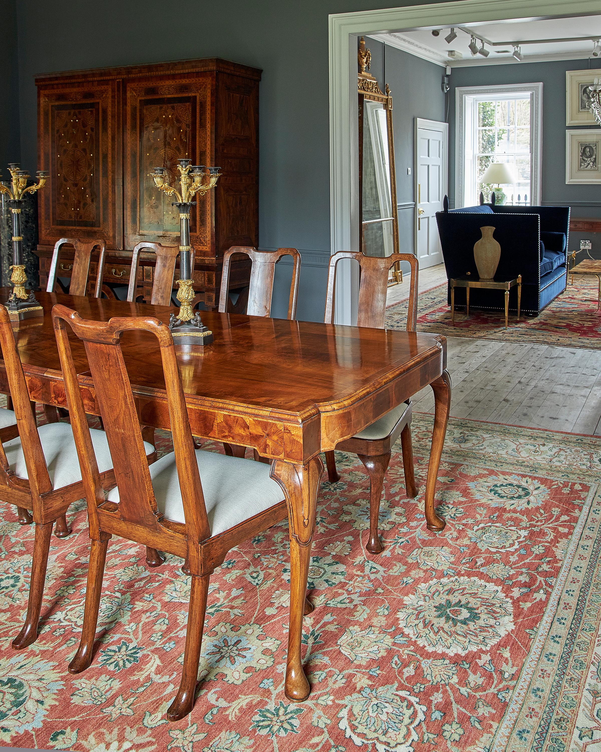 A George I style walnut veneer extending dining table and twelve dining chairs In Good Condition In Petworth, West Sussex