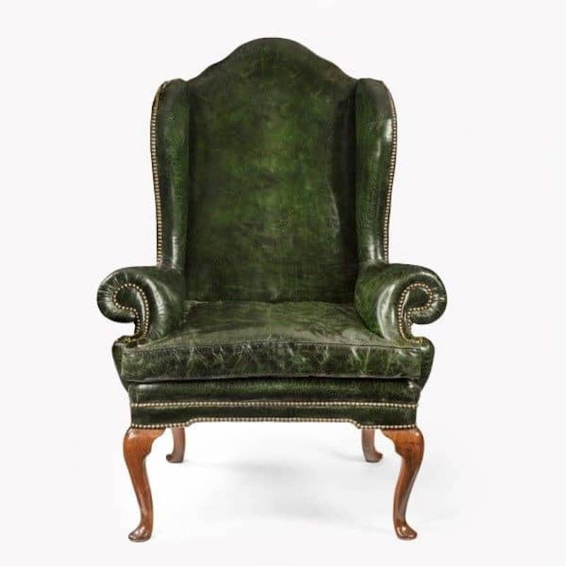 A George I walnut wing armchair of generous proportions re-upholstered in distressed green leather, English, c1720.

H 51 ½ in W 37 ½ in D25in
Seat depth 20in width 28in.