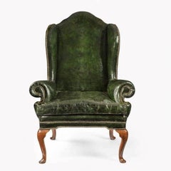A George I walnut wing armchair of generous proportions
