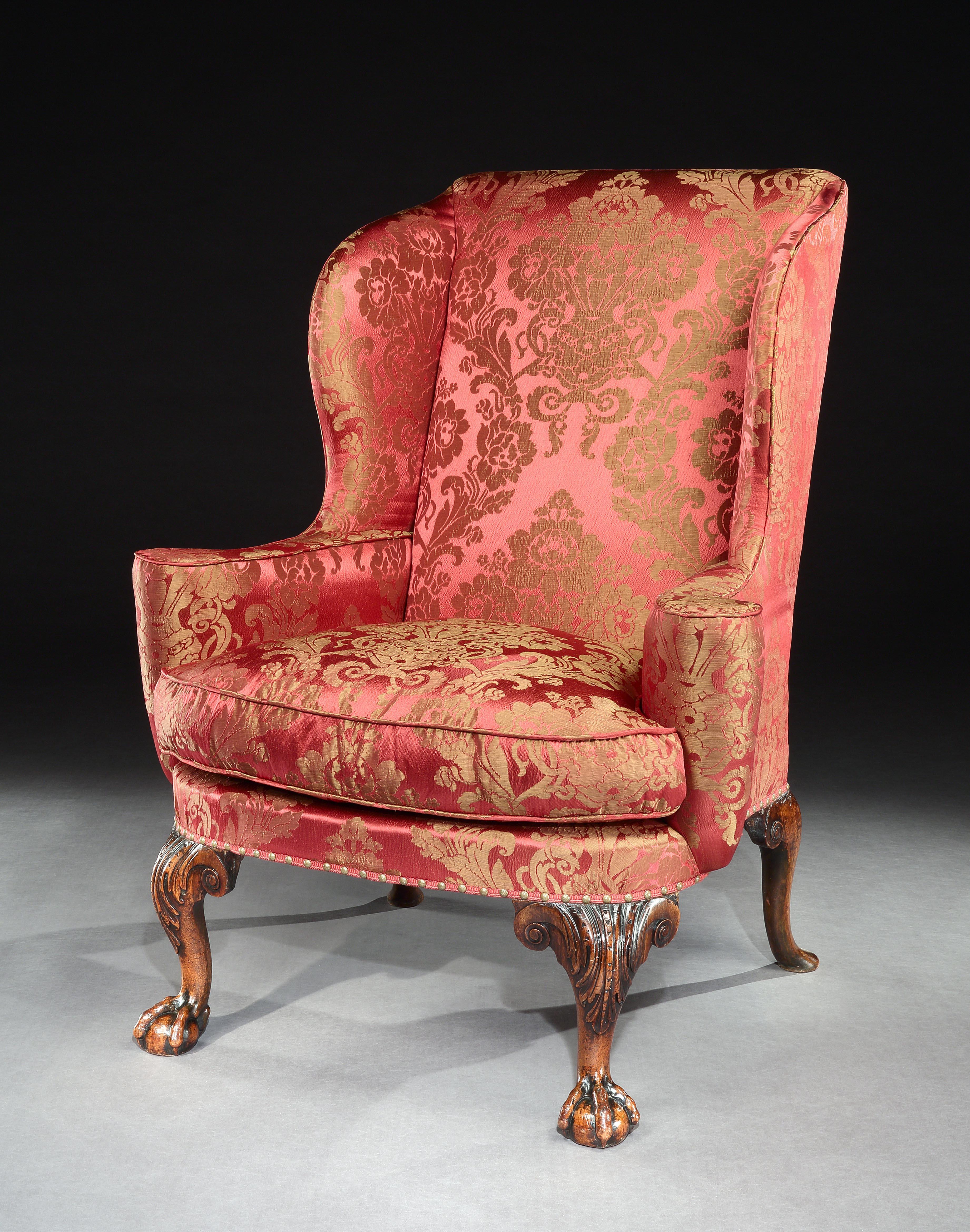 A particularly fine George I walnut wing chair, standing on acanthus carved cabriole legs terminating with ball and claw feet, the back legs well drawn and carved with scrolls.

This fine wing chair benefits from a great color and patina and