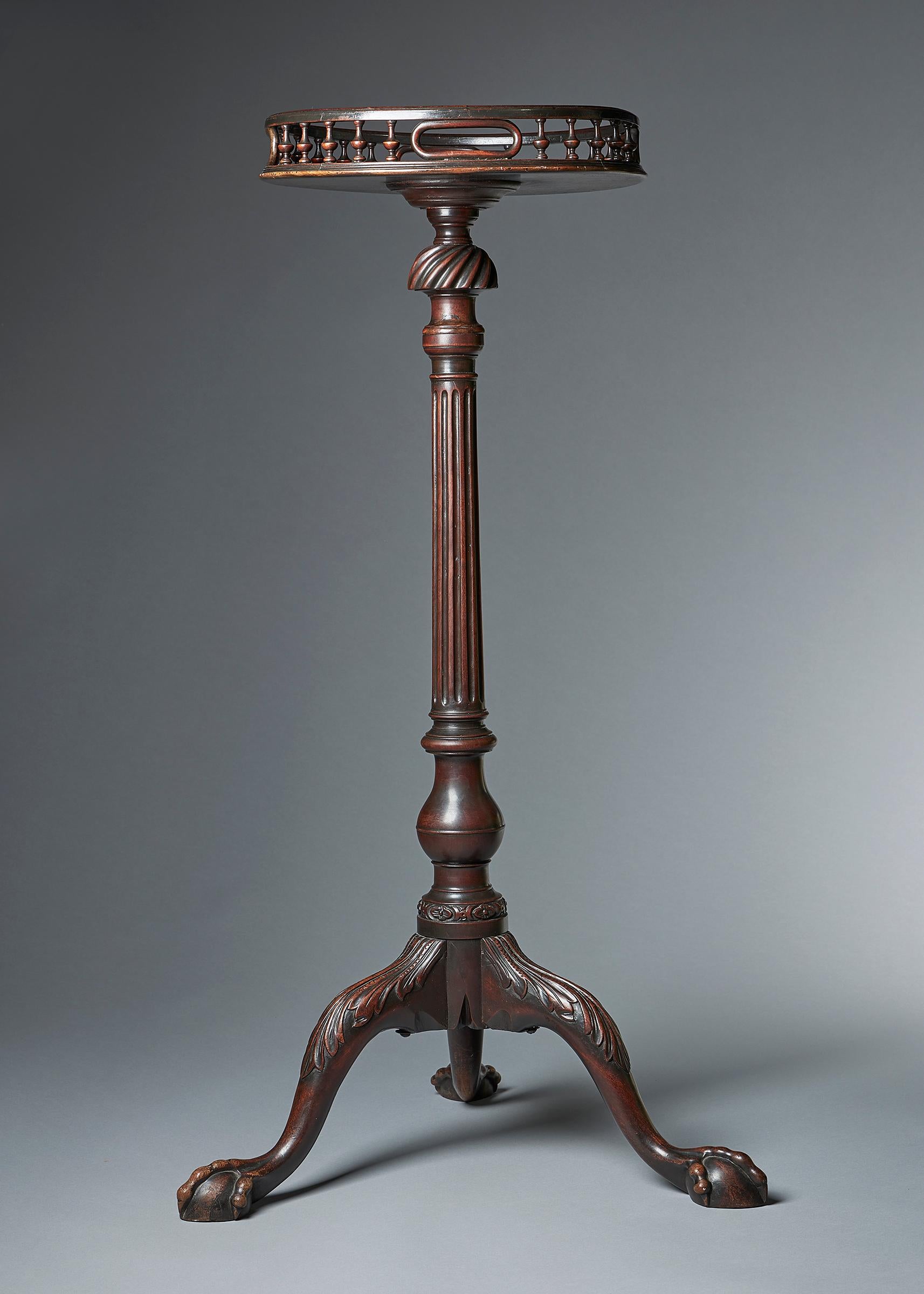 An exquisitely fine and very rare George II mahogany torchiere. 
It is carved to a tripod base on cabriole legs with acanthus leaves terminating on ball-and-claw feet. The baluster and twist baluster reeded column is finely carved to the base in