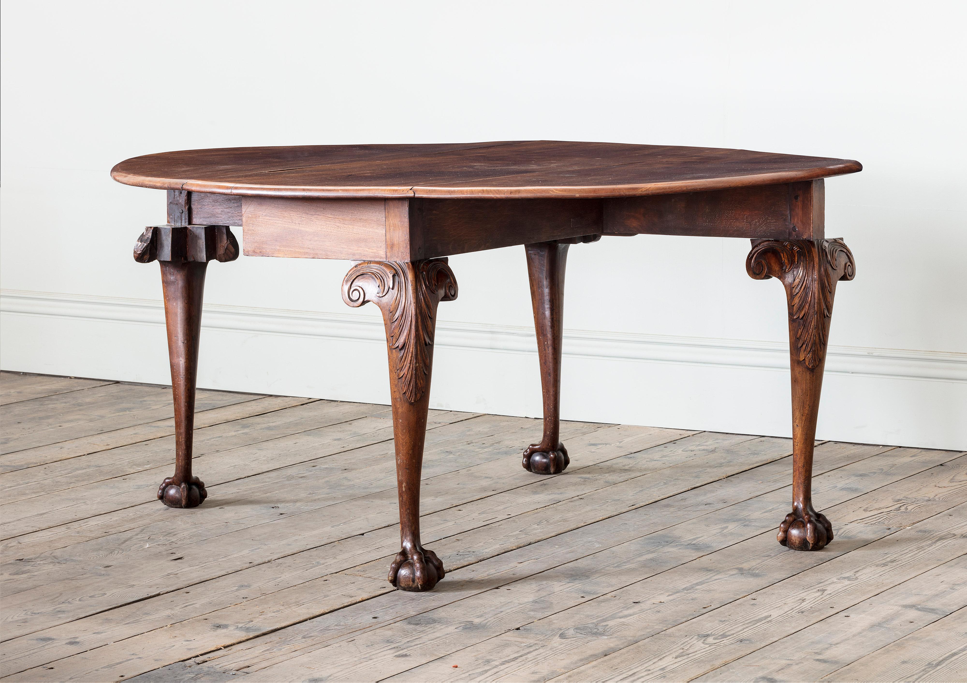 A George II Carved Mahogany Oval Gateleg Drop Leaf Table

With well figured top on acanthus carved cabriole legs on ball and claw feet. c.1755

Length: 138 cm, 54 3/8″
Width with leaves down: 51 cm, 20 1/8″
Width with leaves up: 154 cm, 60