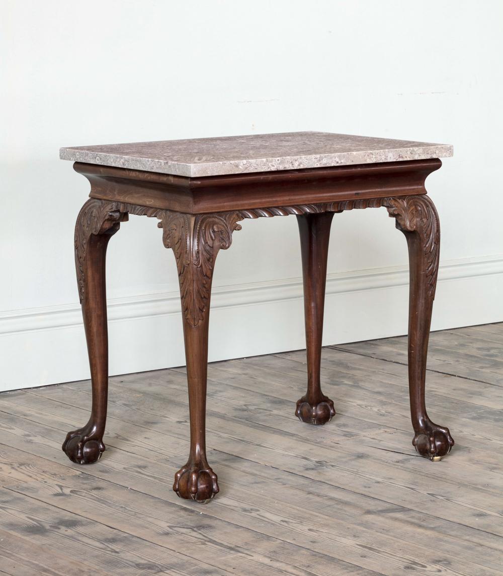 A George II Carved Mahogany Side Table

With contemporary Derbyshire fossil top, above a cavetto frieze and gadrooned apron on pronounced acanthus carved cabriole legs with claw and ball feet.

Scottish, c.1755, attributed to Francis Brodie

Width: