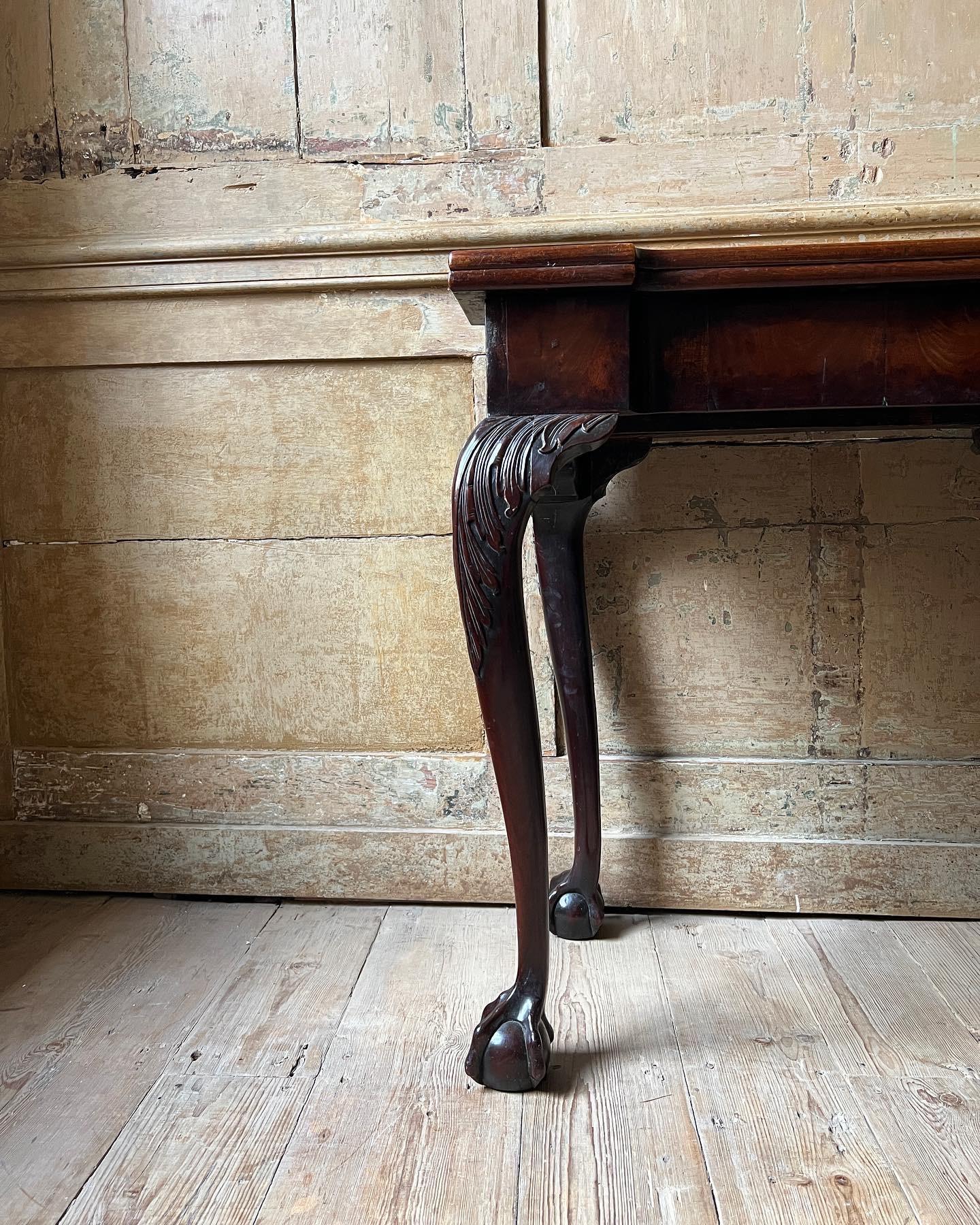 A George II mahogany tea table, England, c.1740. With carved acanthus knees and ball & claw feet to all four sides, opening with a rear gateleg action. Fantastic colour & patina to the surfaces.

Measures - 73cm H x 74 W x 42cm D.

