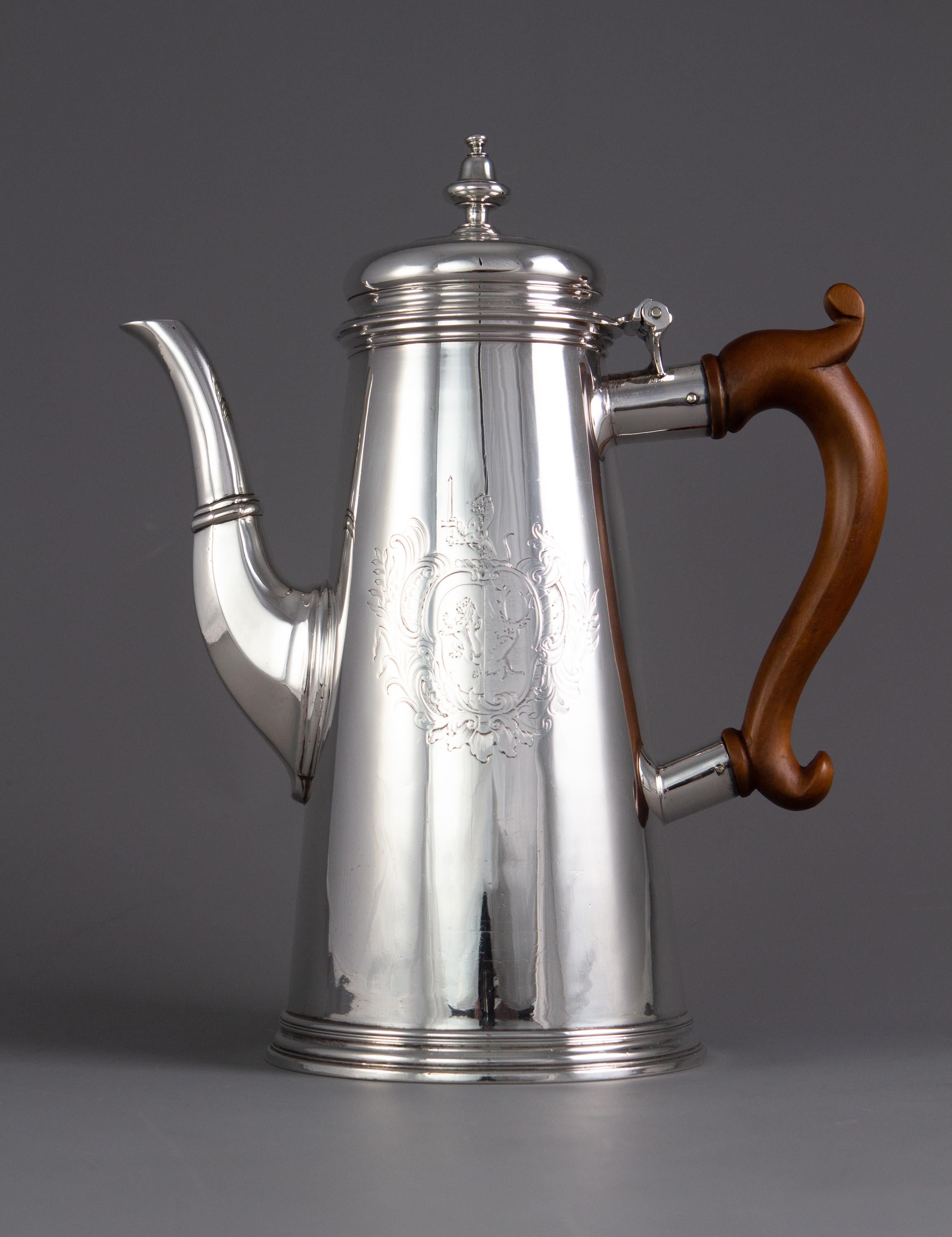 A superb George II silver coffee pot London 1730 by Thomas Farren.

 A very fine example of an early George II silver coffee pot of circular tapered form with an octagonal shaped spout and domed lid with acorn finial. Standing on a step foot with